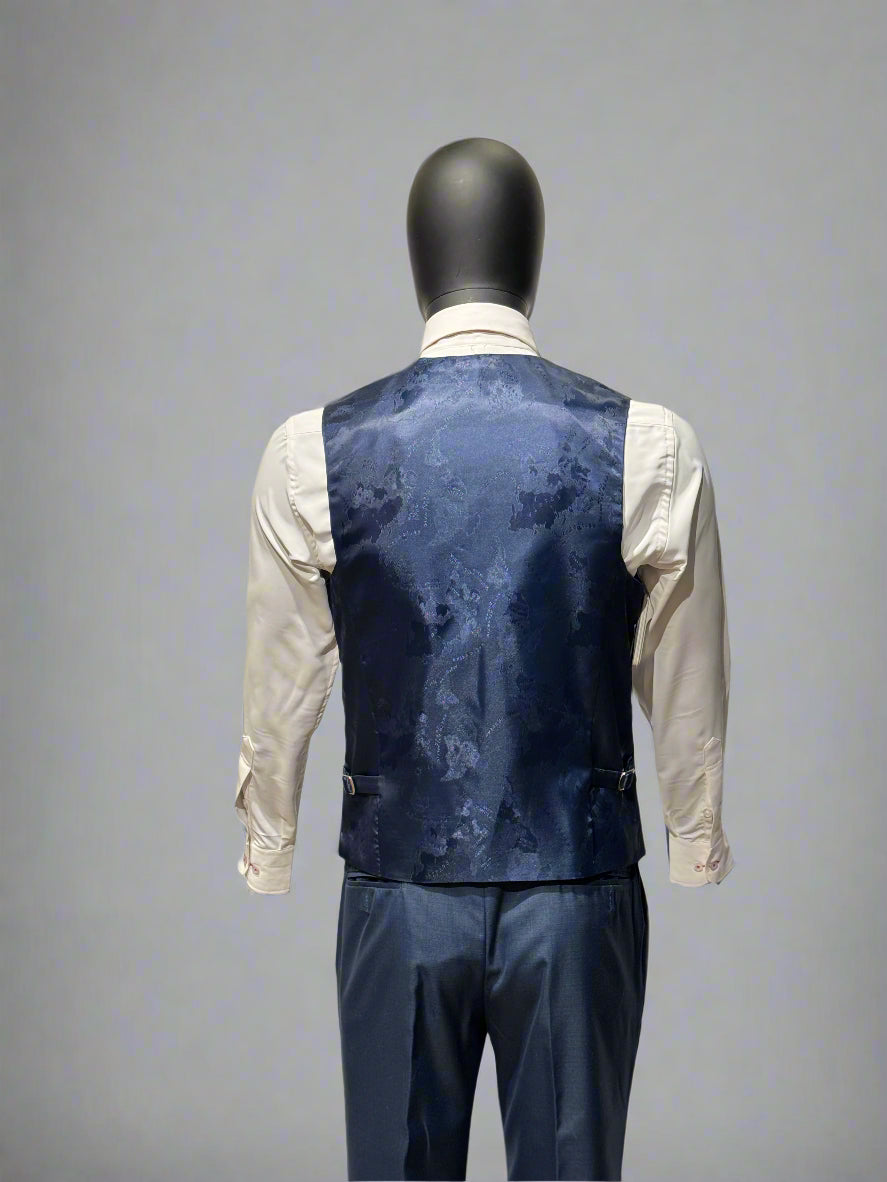 Mannequin wearing a navy floral-patterned vest over a white shirt on a gray background