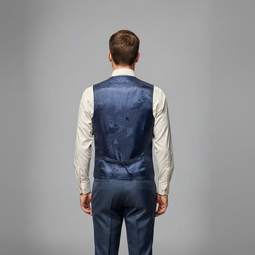 Mannequin wearing a navy floral-patterned vest over a white shirt on a gray background