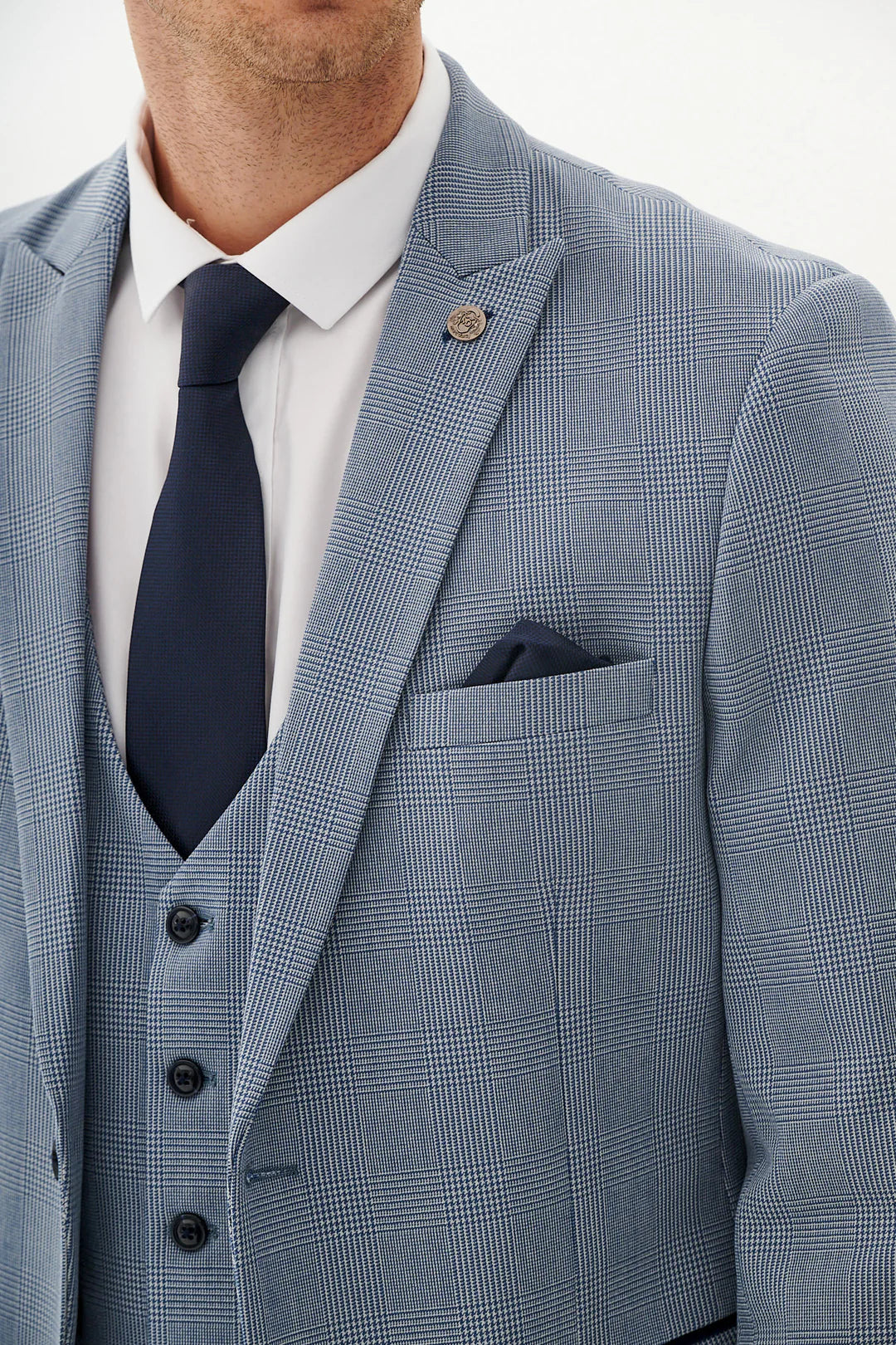 Blue checkered suit with white shirt and dark tie.