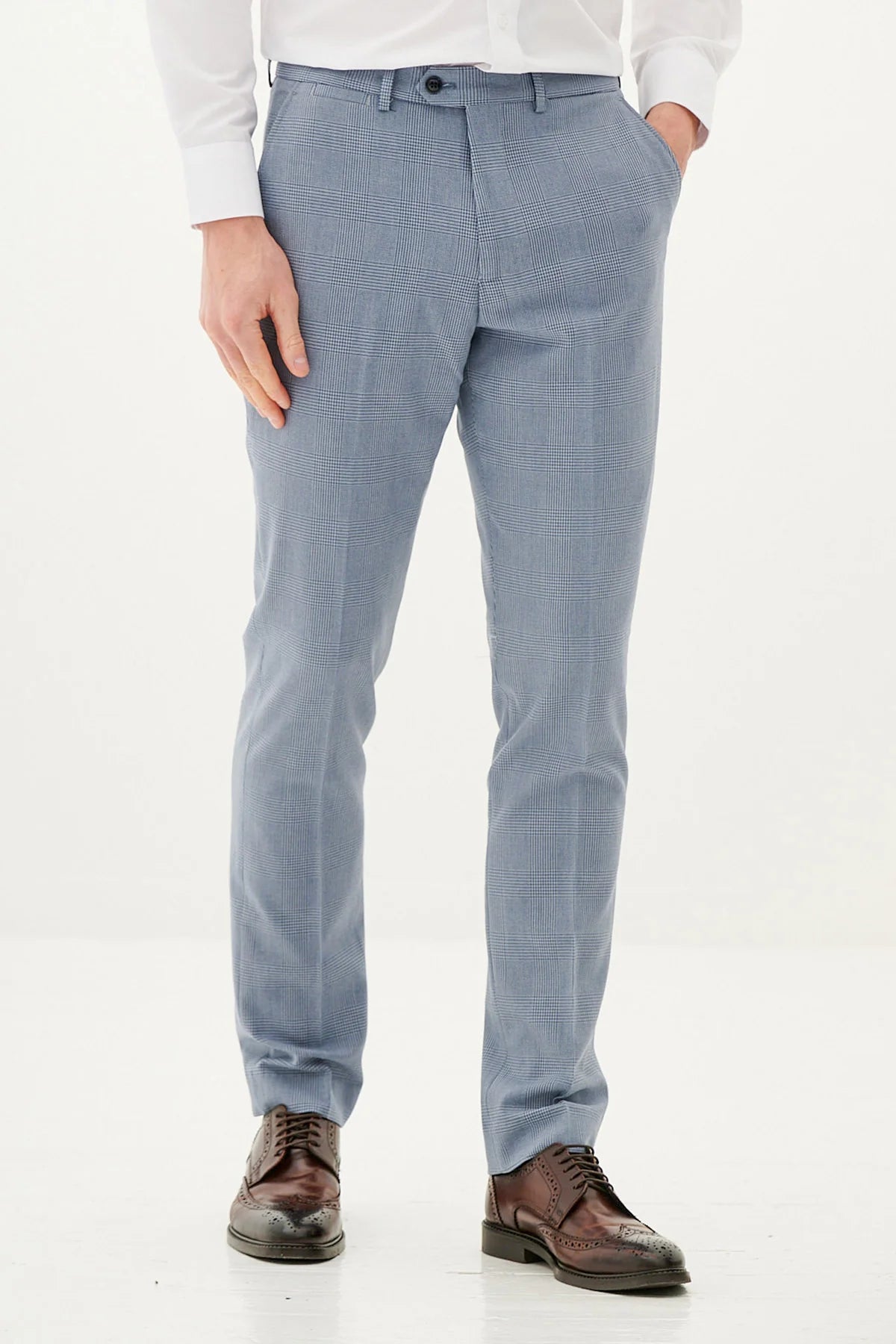 Person wearing light blue pants on a plain background