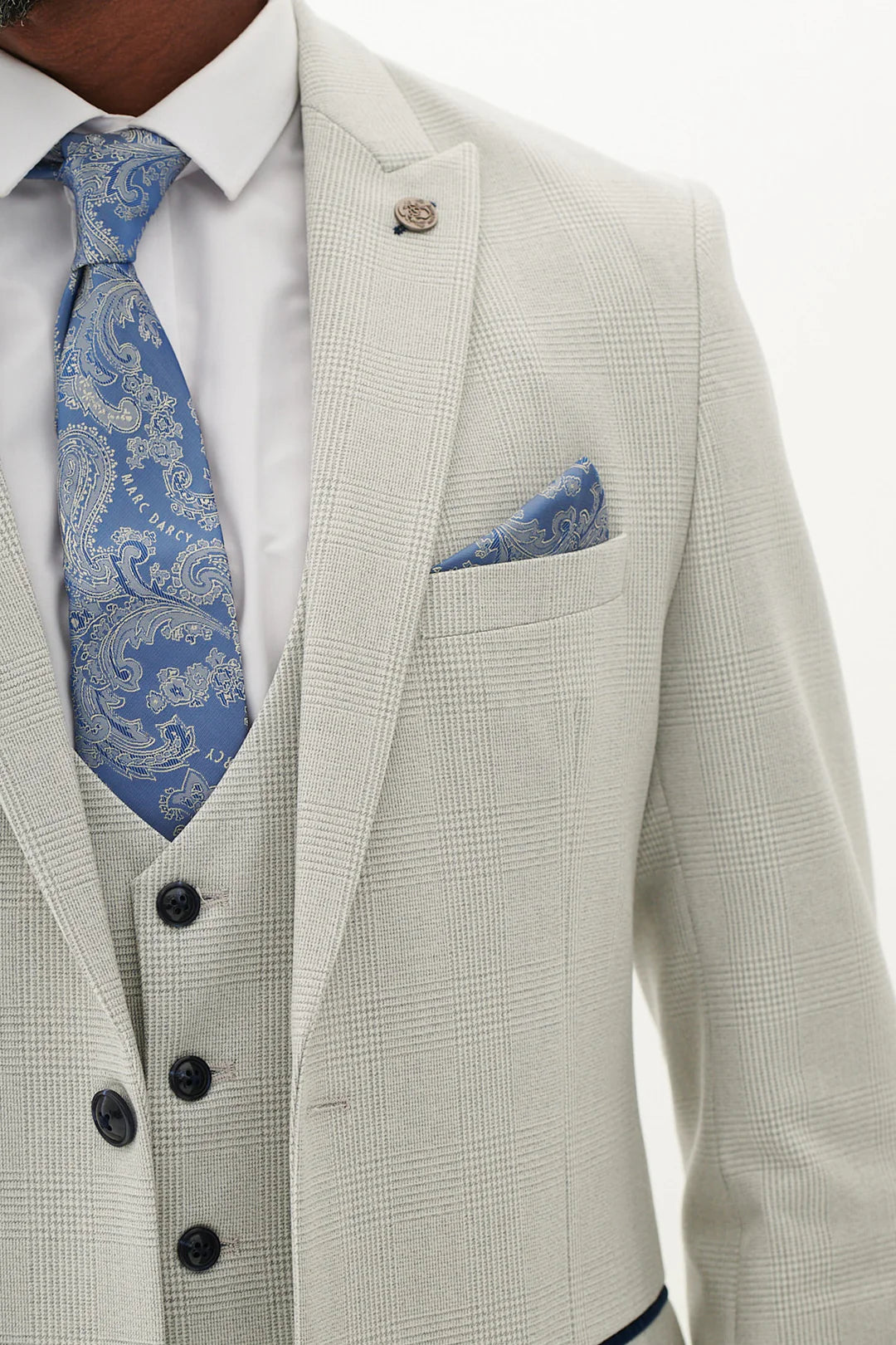 Light gray blazer with blue paisley tie and pocket square.