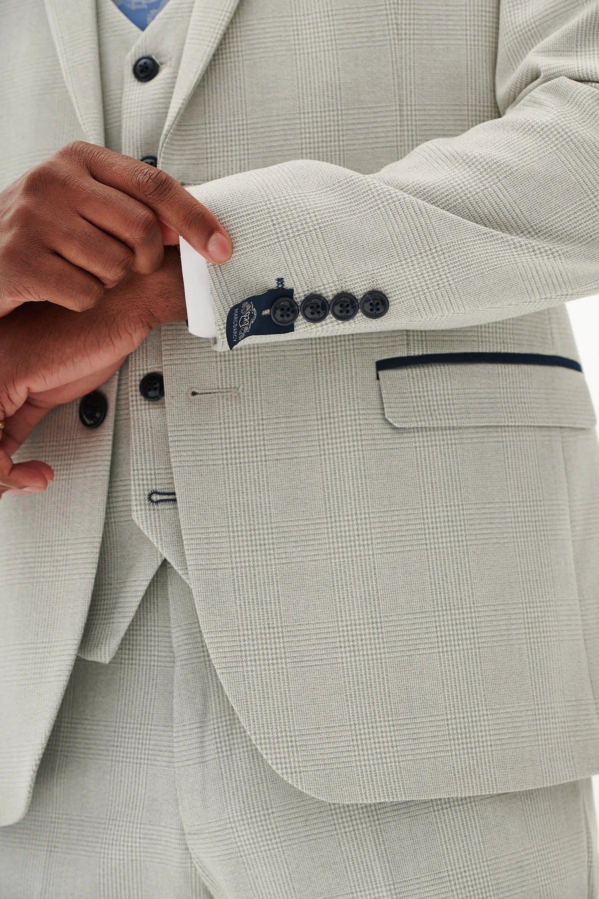 Light gray suit jacket with button details on a plain background