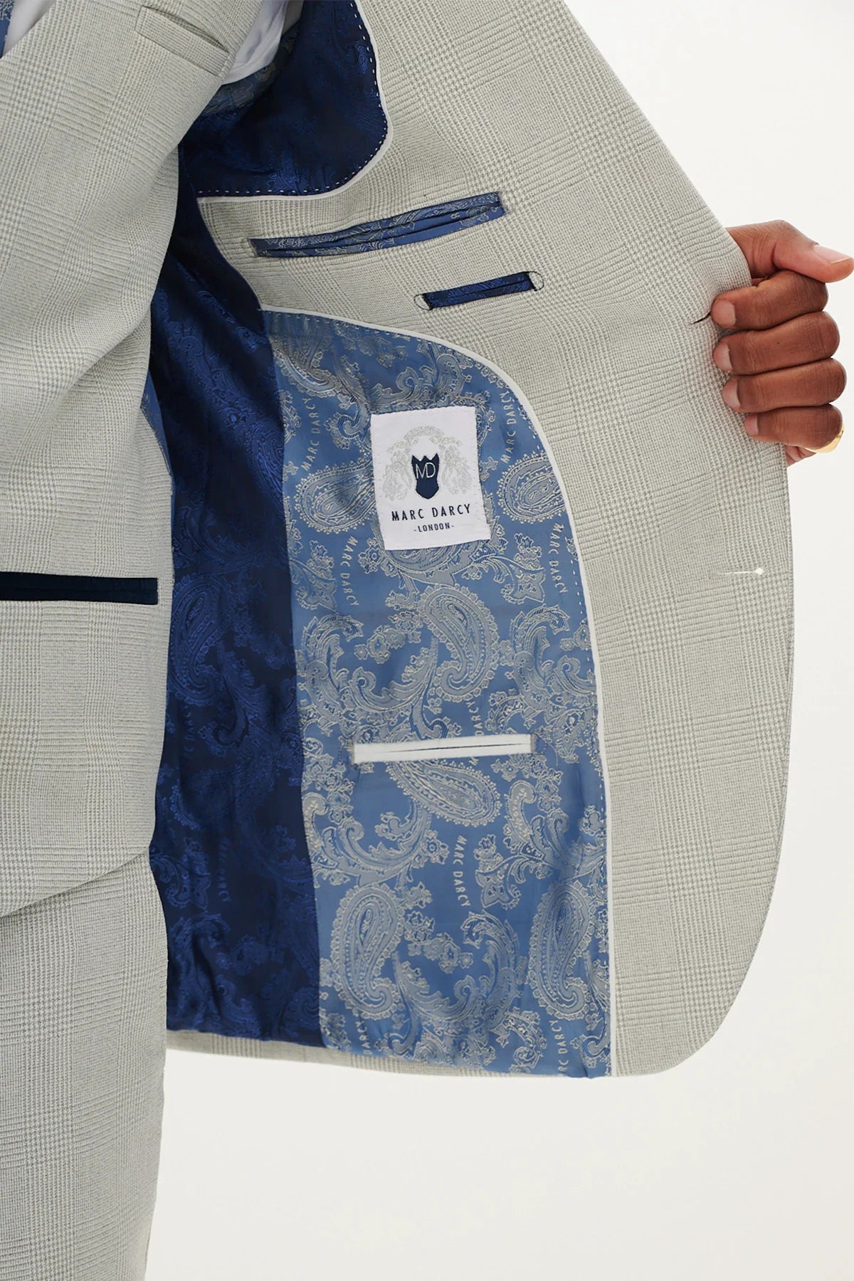 Close-up of a light gray blazer with a blue paisley lining.