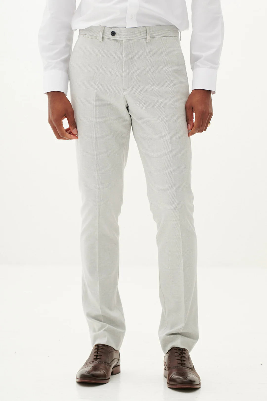 Light gray pants worn by a person on a white background