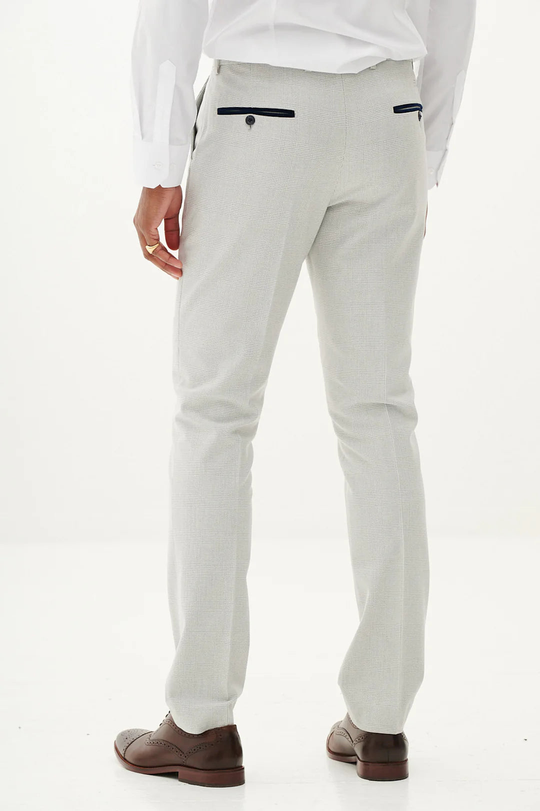 Light gray pants worn by a person on a plain background
