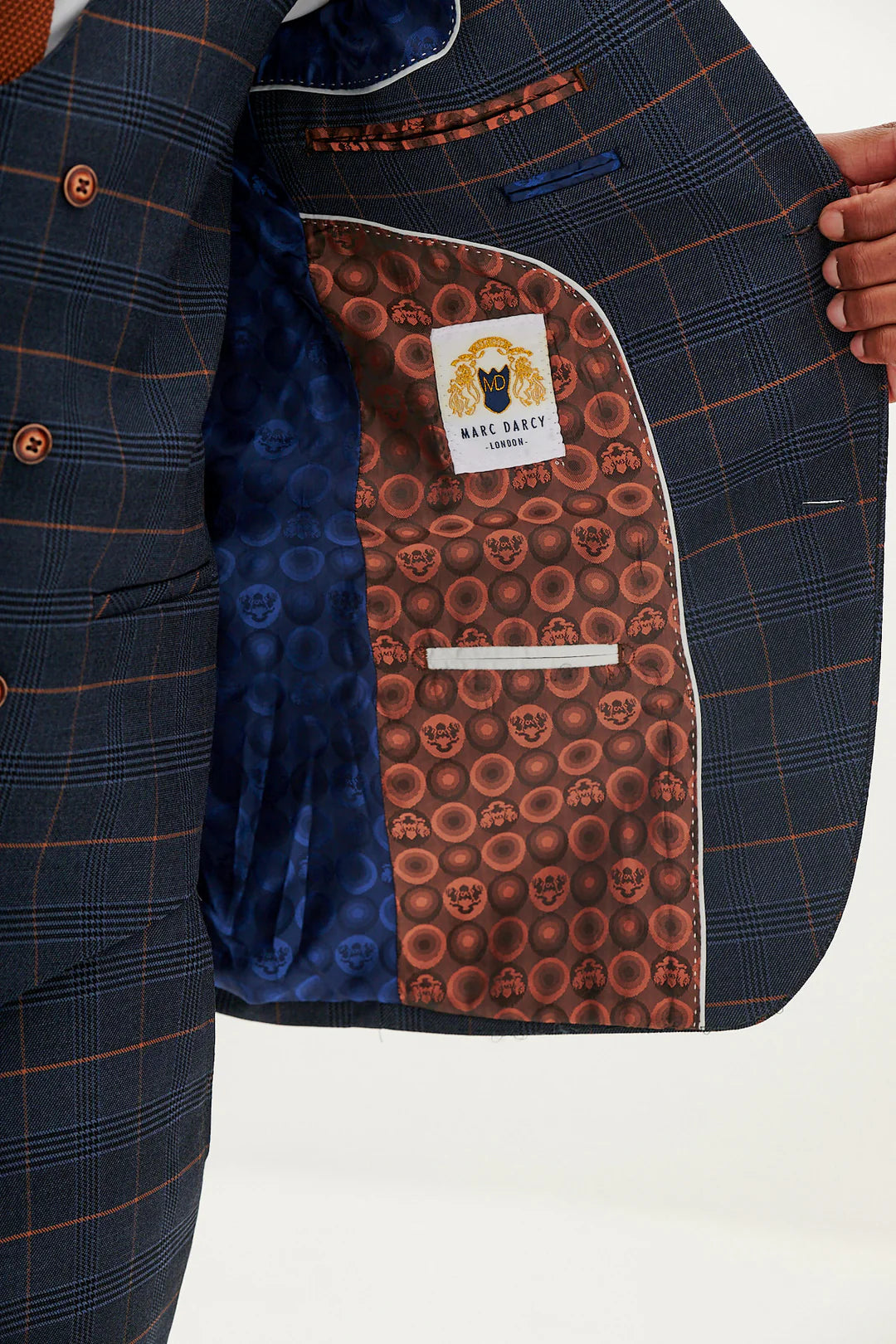 Close-up of a suit jacket with a patterned interior and logo.