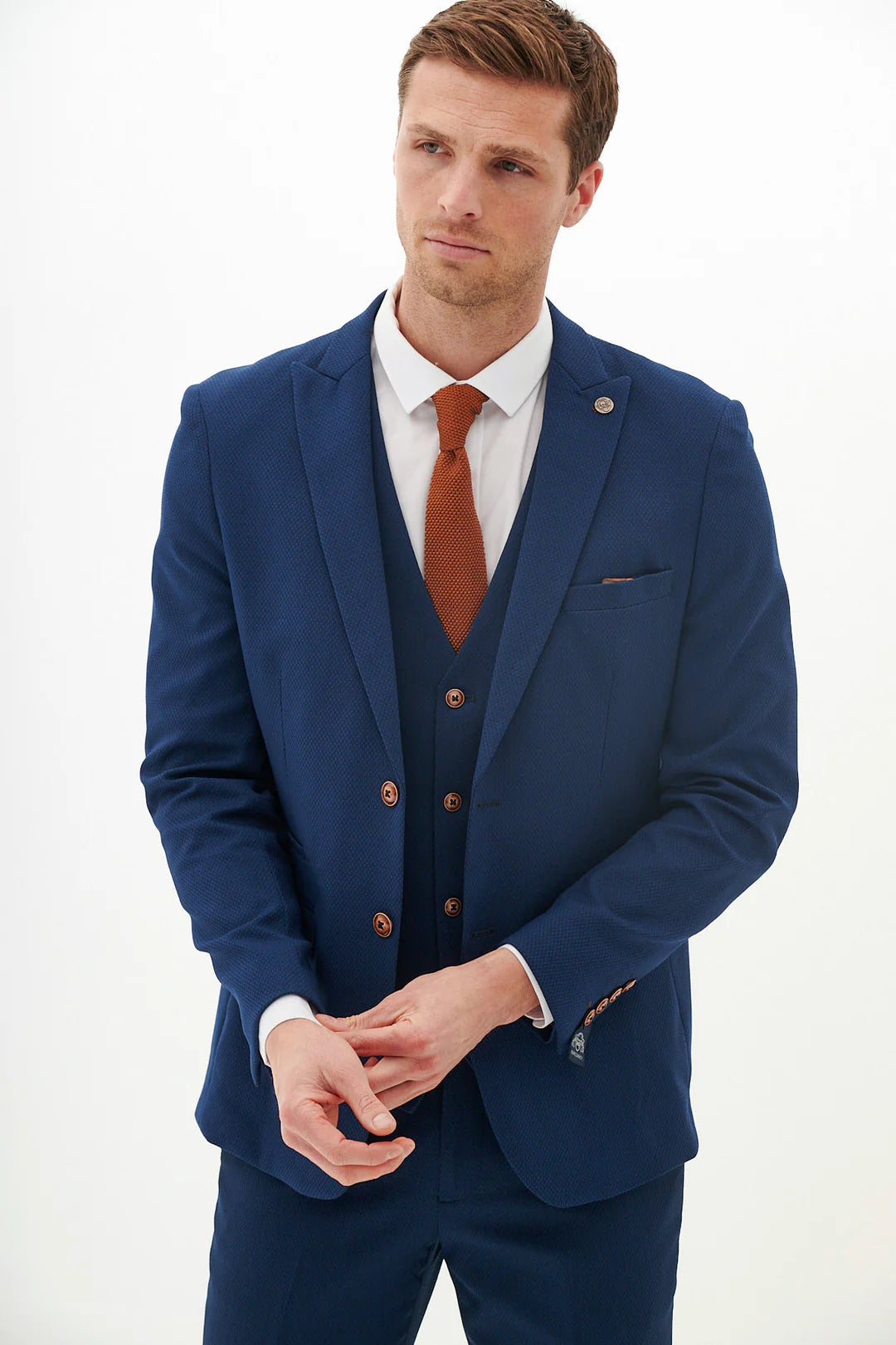 Man wearing a blue suit with a red tie on a white background