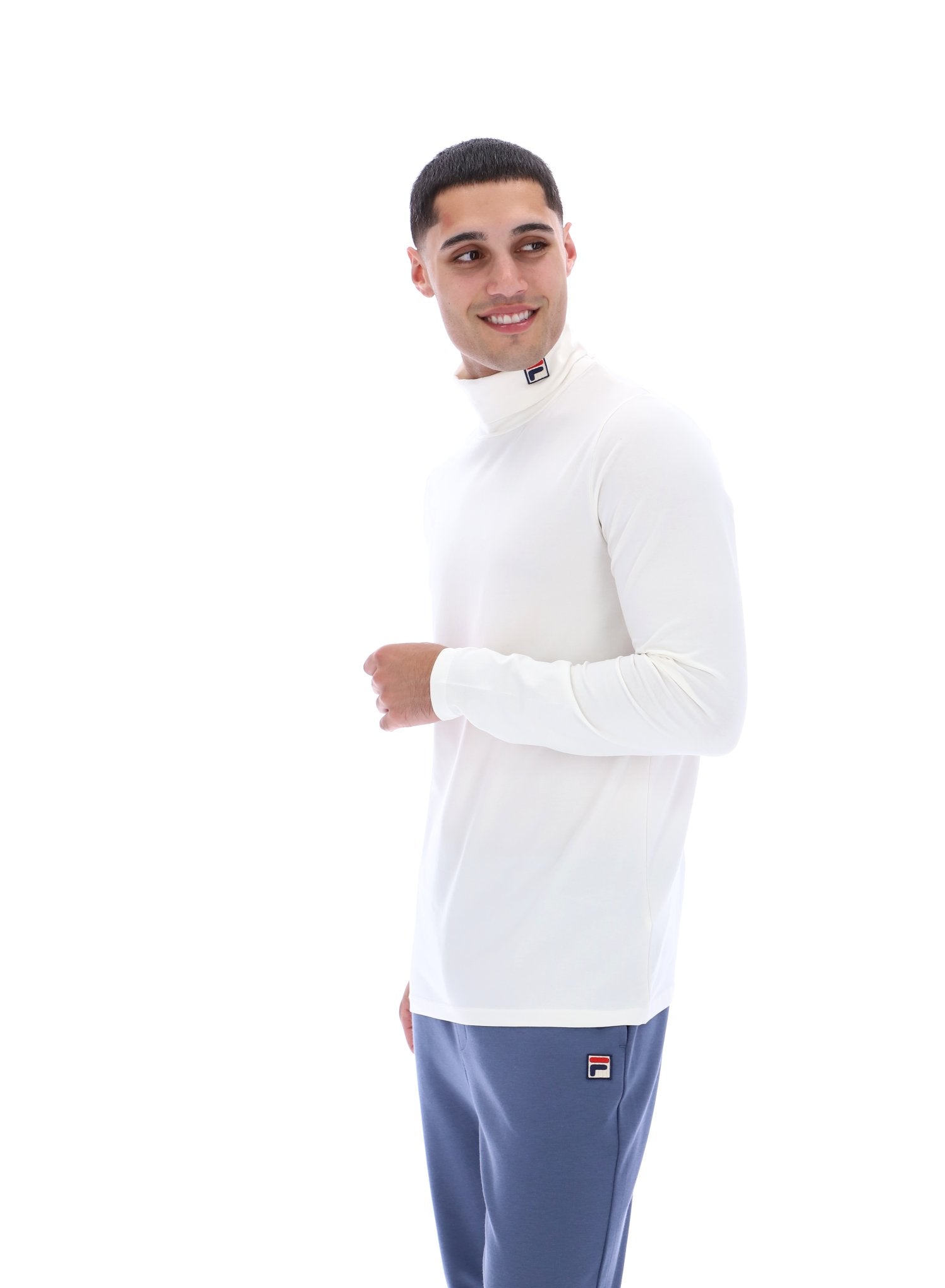 Man wearing a white long-sleeve shirt and blue pants on a white background