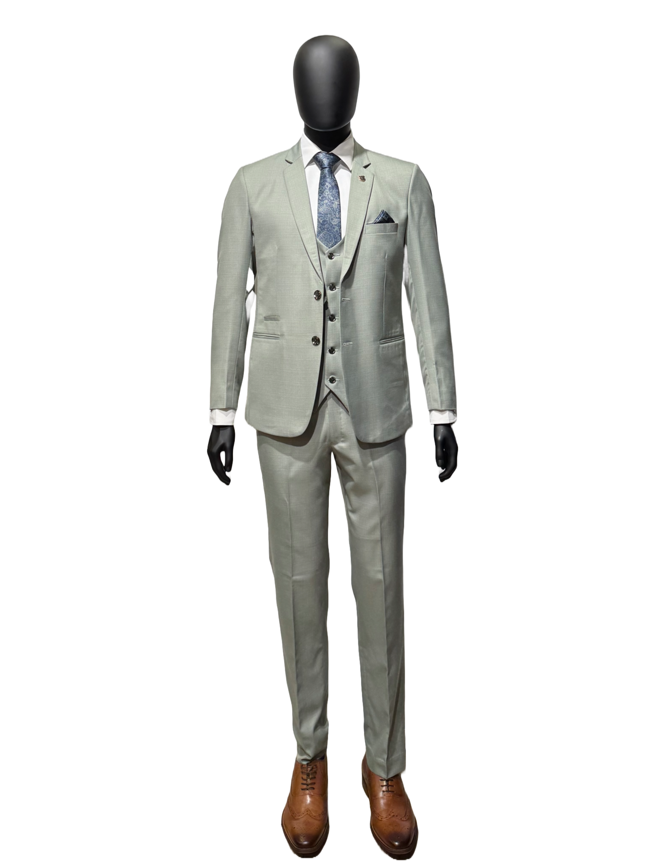 A three-piece sage suit on a mannequin, featuring a jacket, trousers, and a vest, with a patterned tie and brown shoes.