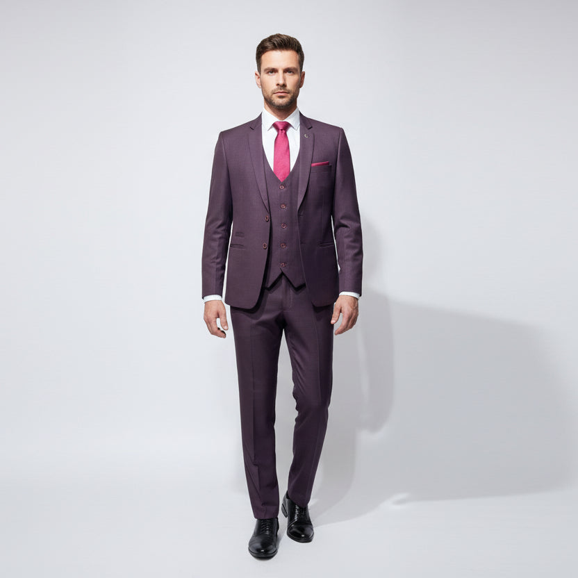 A three-piece wine-colored men's suit displayed on a mannequin, consisting of a jacket, trousers, and a tie.