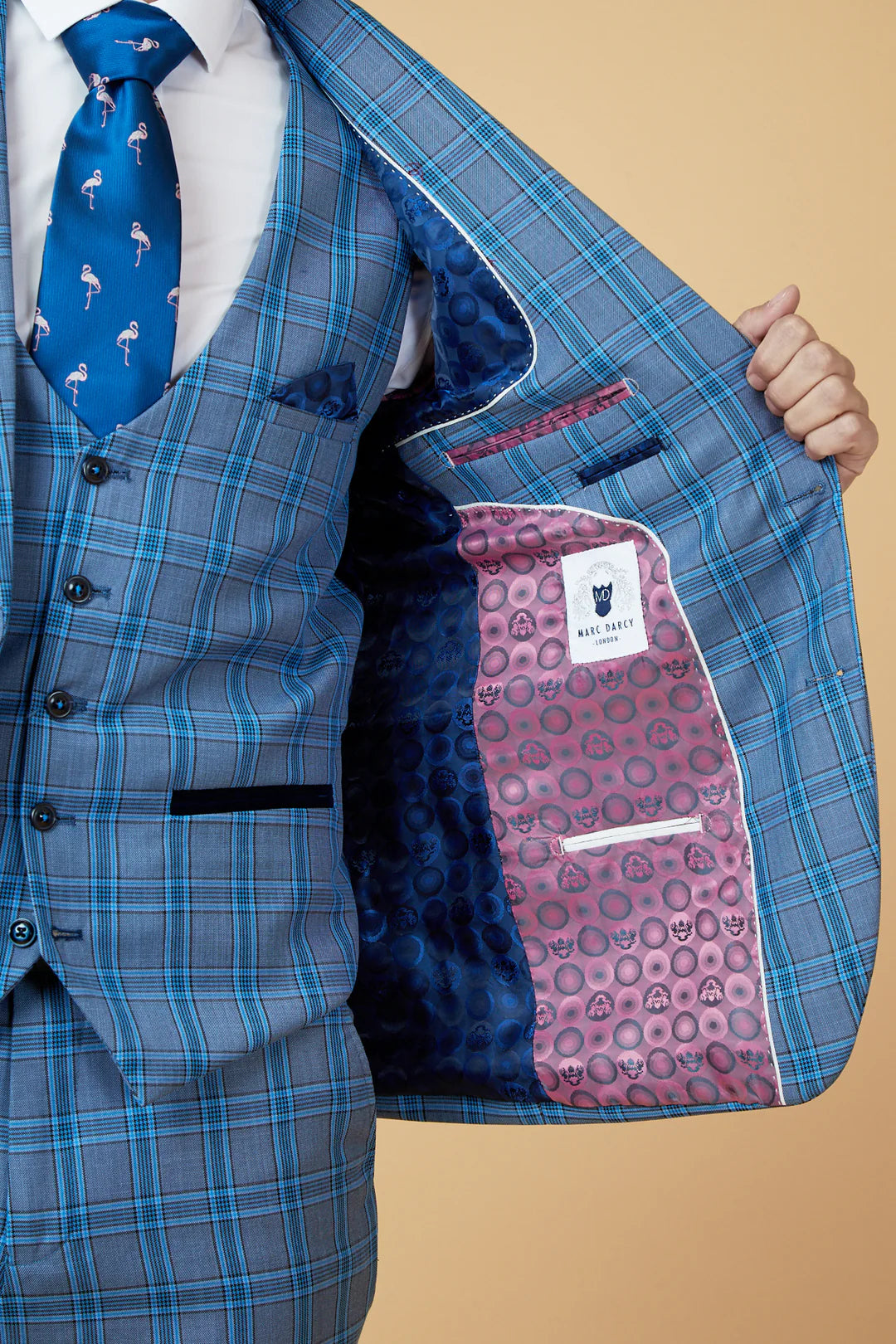 Blue plaid suit jacket with a patterned lining on a beige background