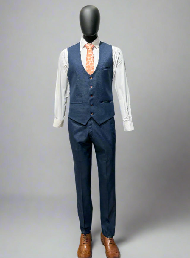 Navy blue suit with a white shirt and brown shoes on a gray background