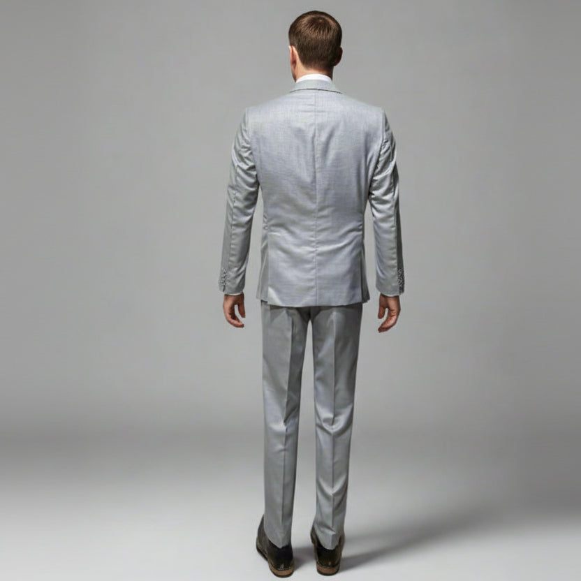 Mannequin wearing a light gray suit on a plain background