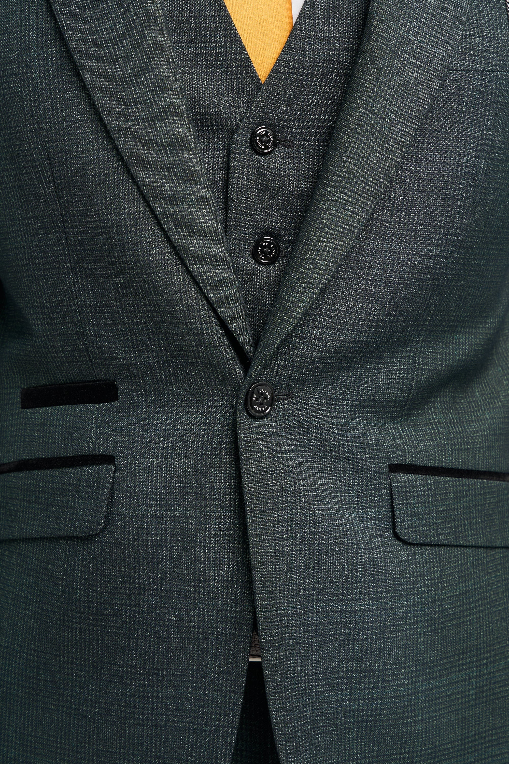 Close-up of a dark green suit with buttons and chest pockets.