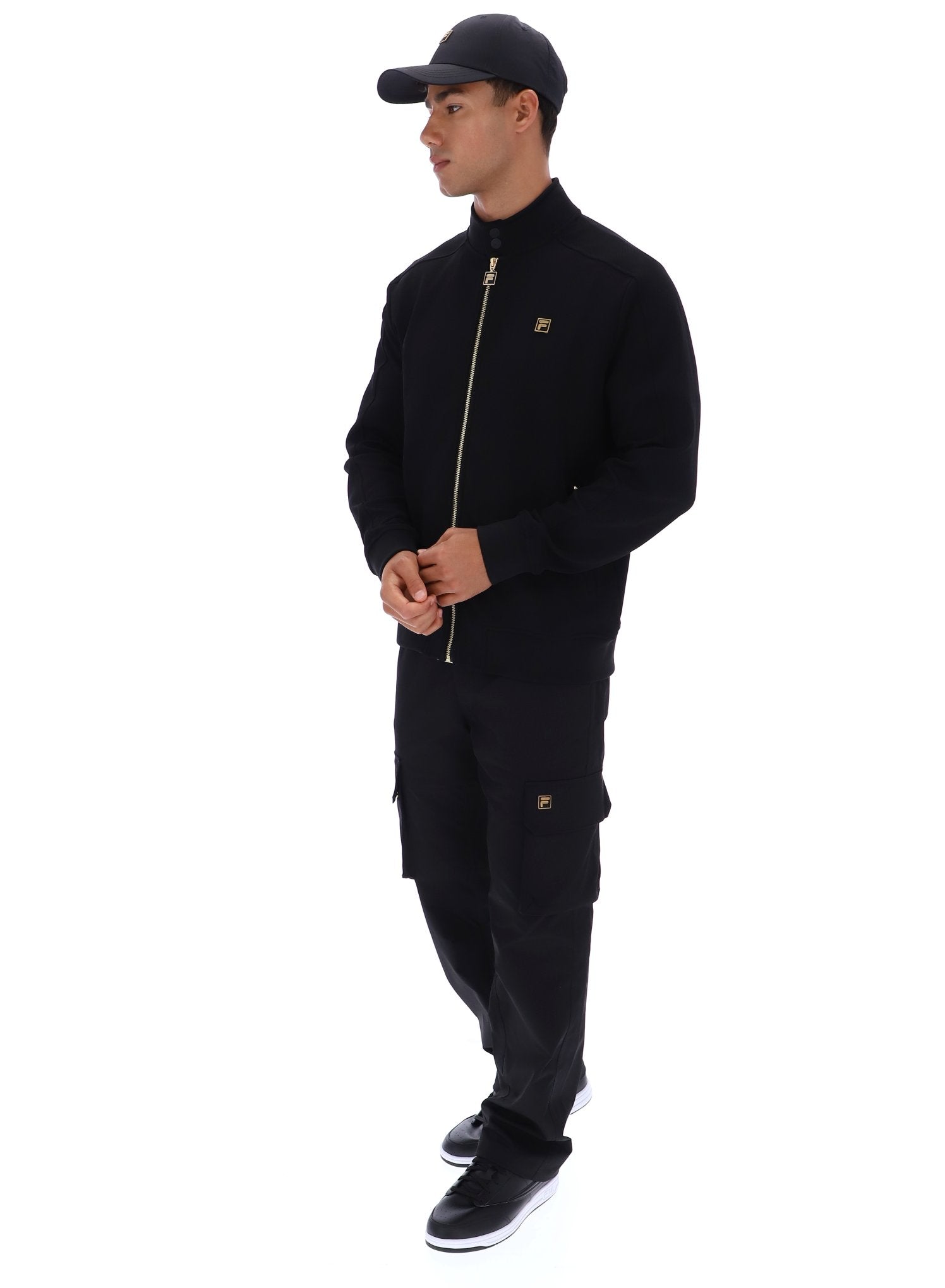 Man wearing a black tracksuit with a brand logo on a white background