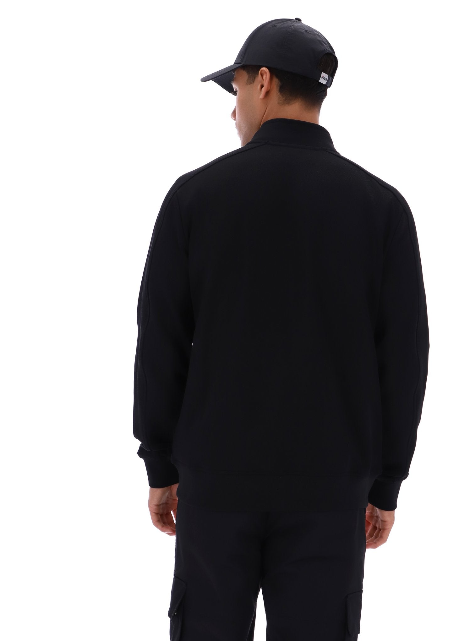 Person wearing a black jacket and cap on a white background