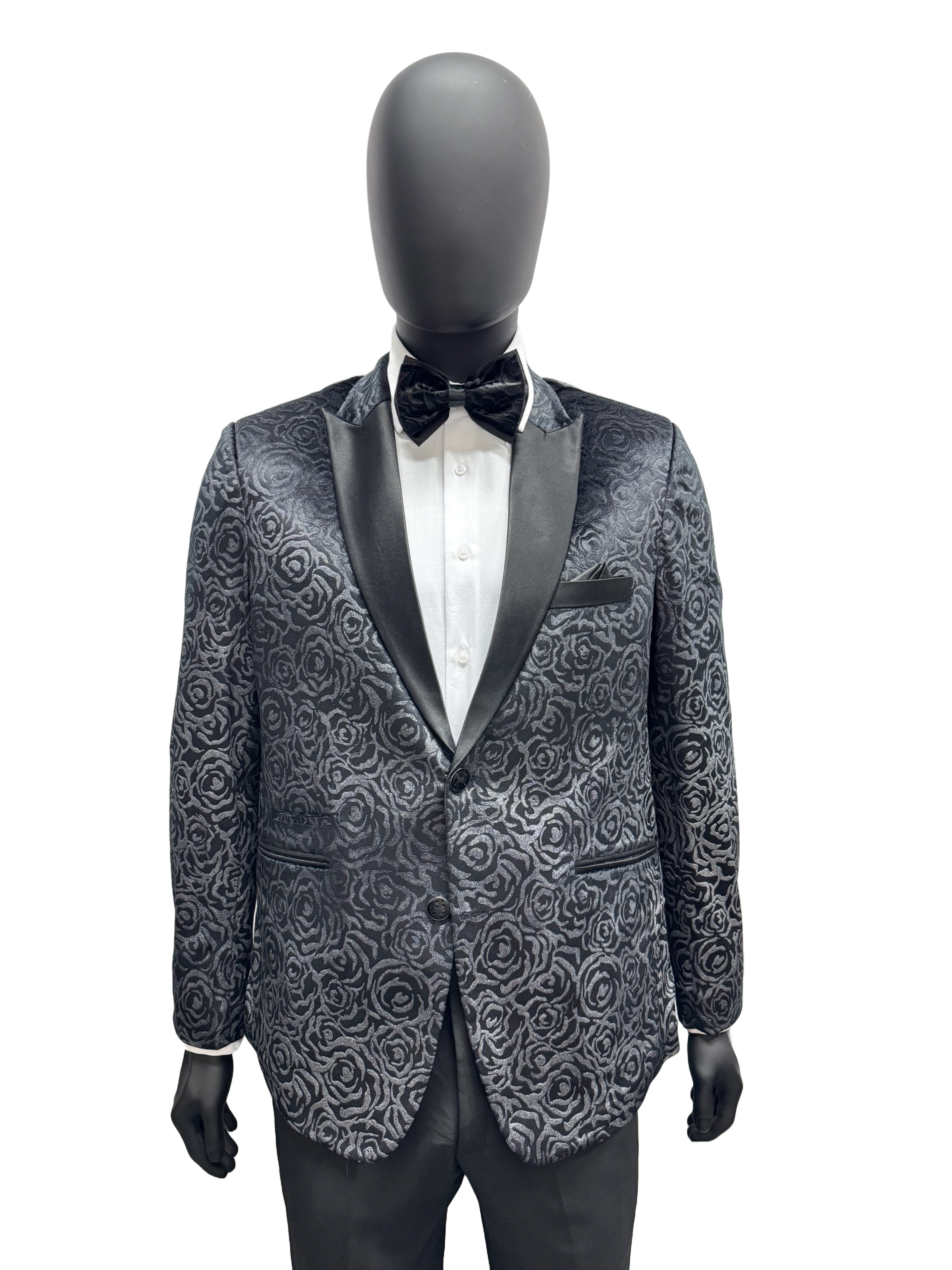 Mannequin wearing a black paisley dinner jacket with a bow tie on a white background.