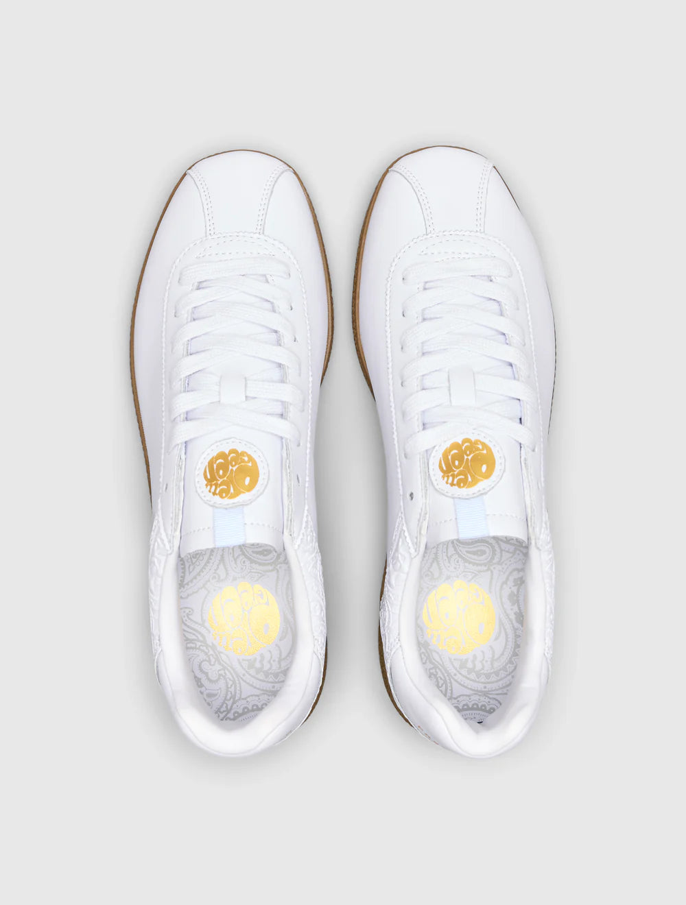 A white Pretty Green trainer with a microfibre suede upper, paisley graphic and logo on the insert, and a contrast spoiler on the rubber gum outsole.