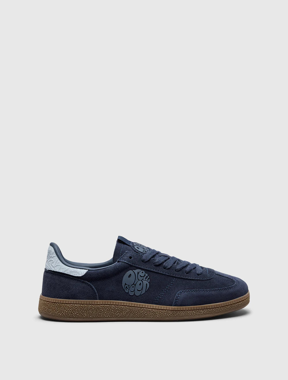 A navy-colored Pretty Green trainer with a suede upper, paisley graphic and logo, and a rubber gum outsole.