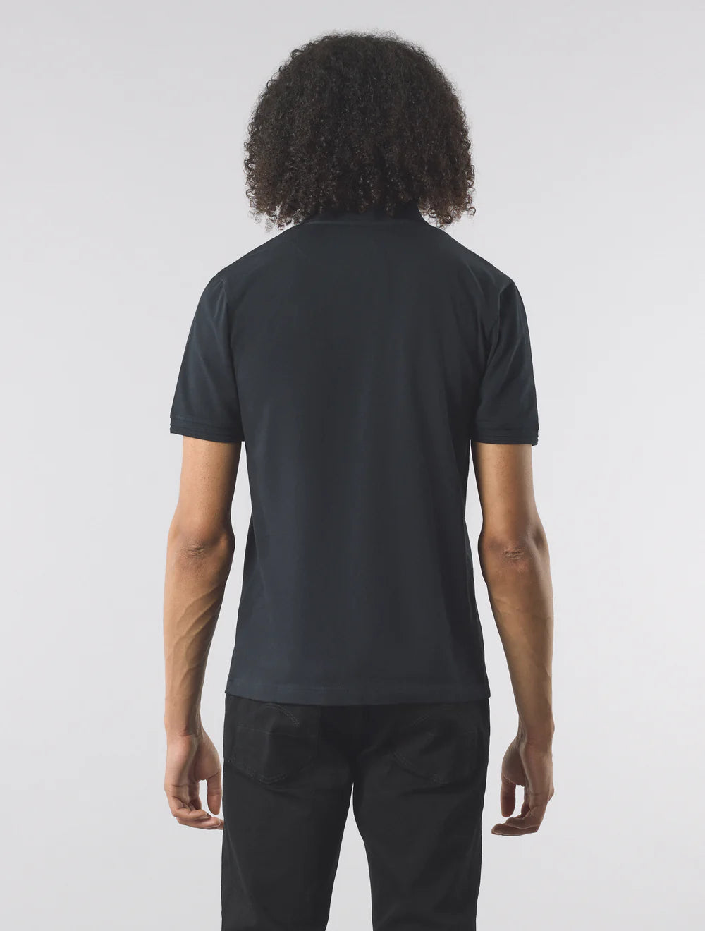 Person wearing a black t-shirt and pants on a white background
