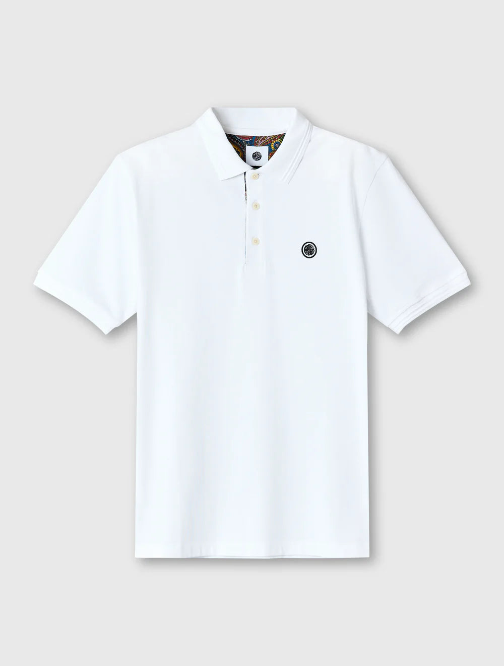 White polo shirt with a small logo on a light gray background