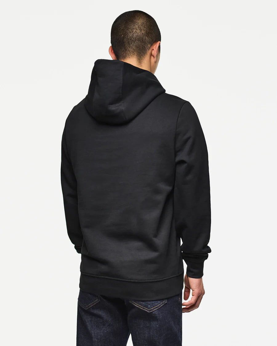Person wearing a black hoodie from behind on a light gray background