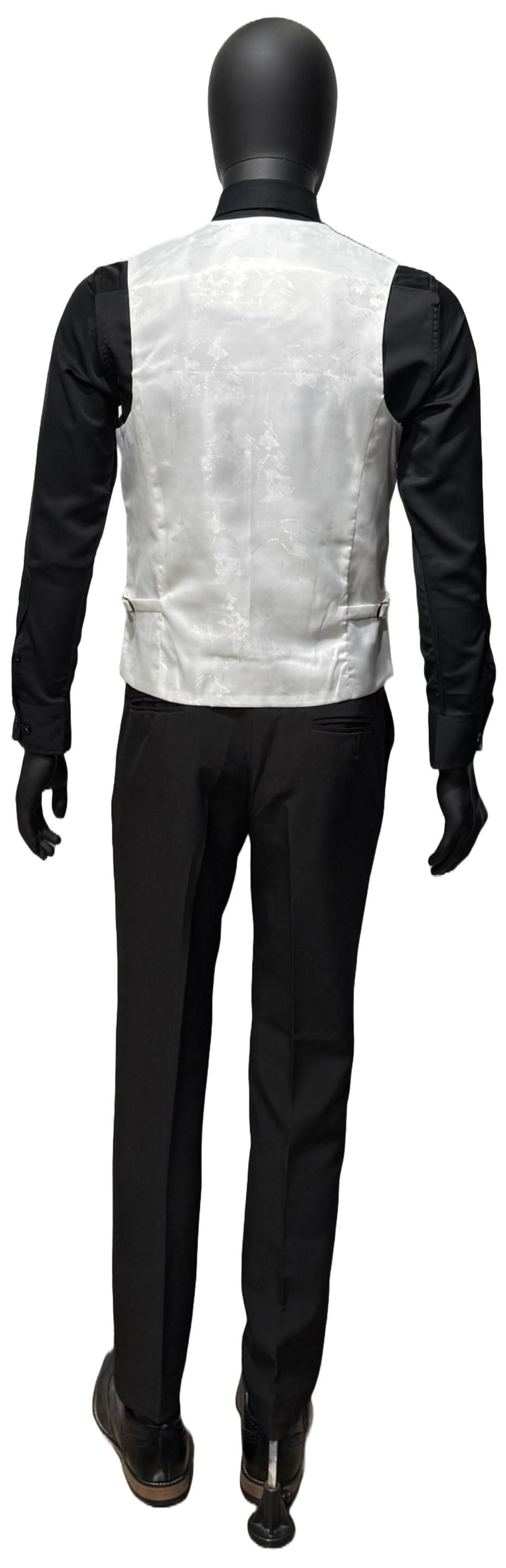 A mannequin wearing a white tuxedo on a white background