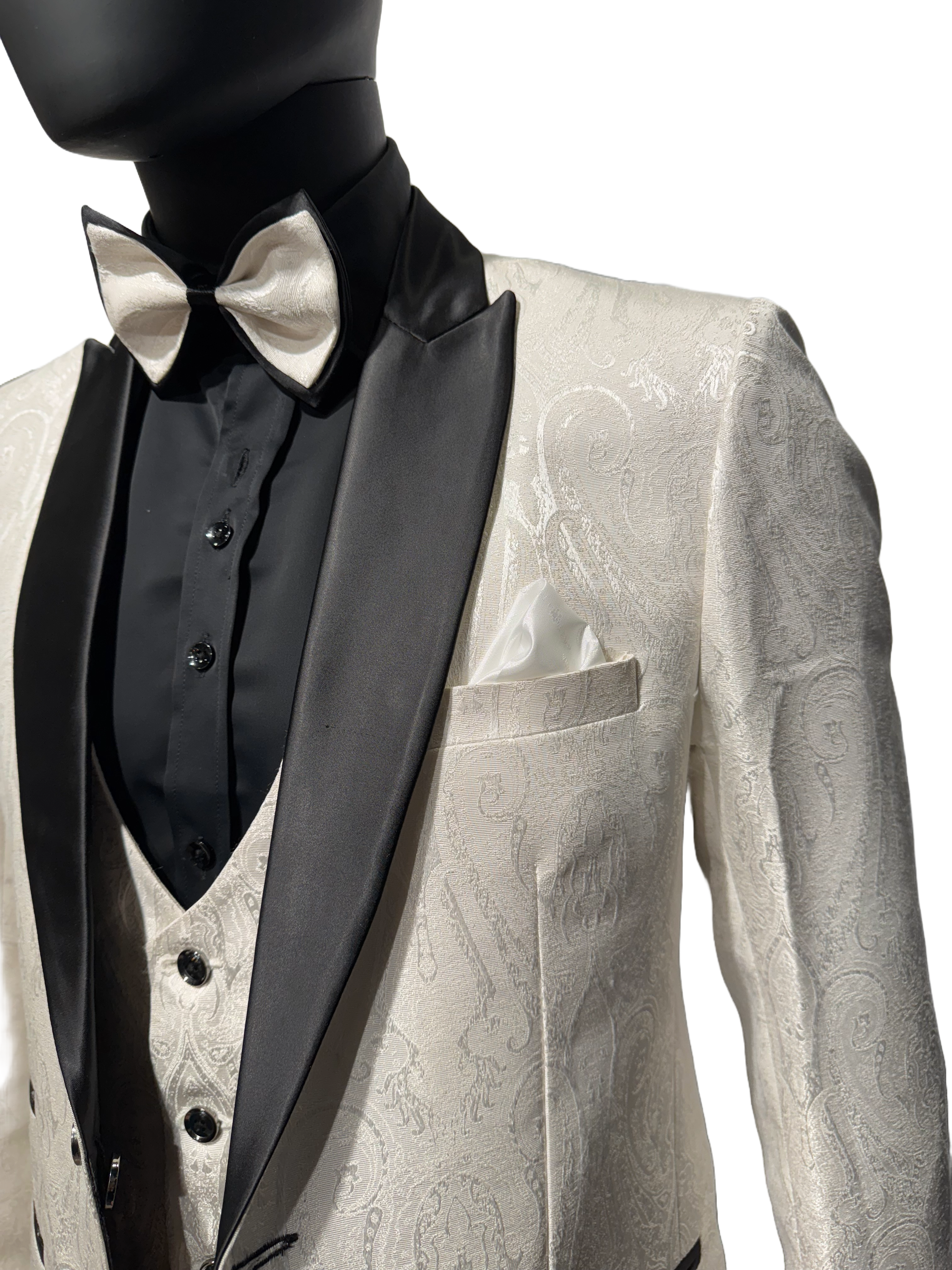 A mannequin wearing a white tuxedo on a white background