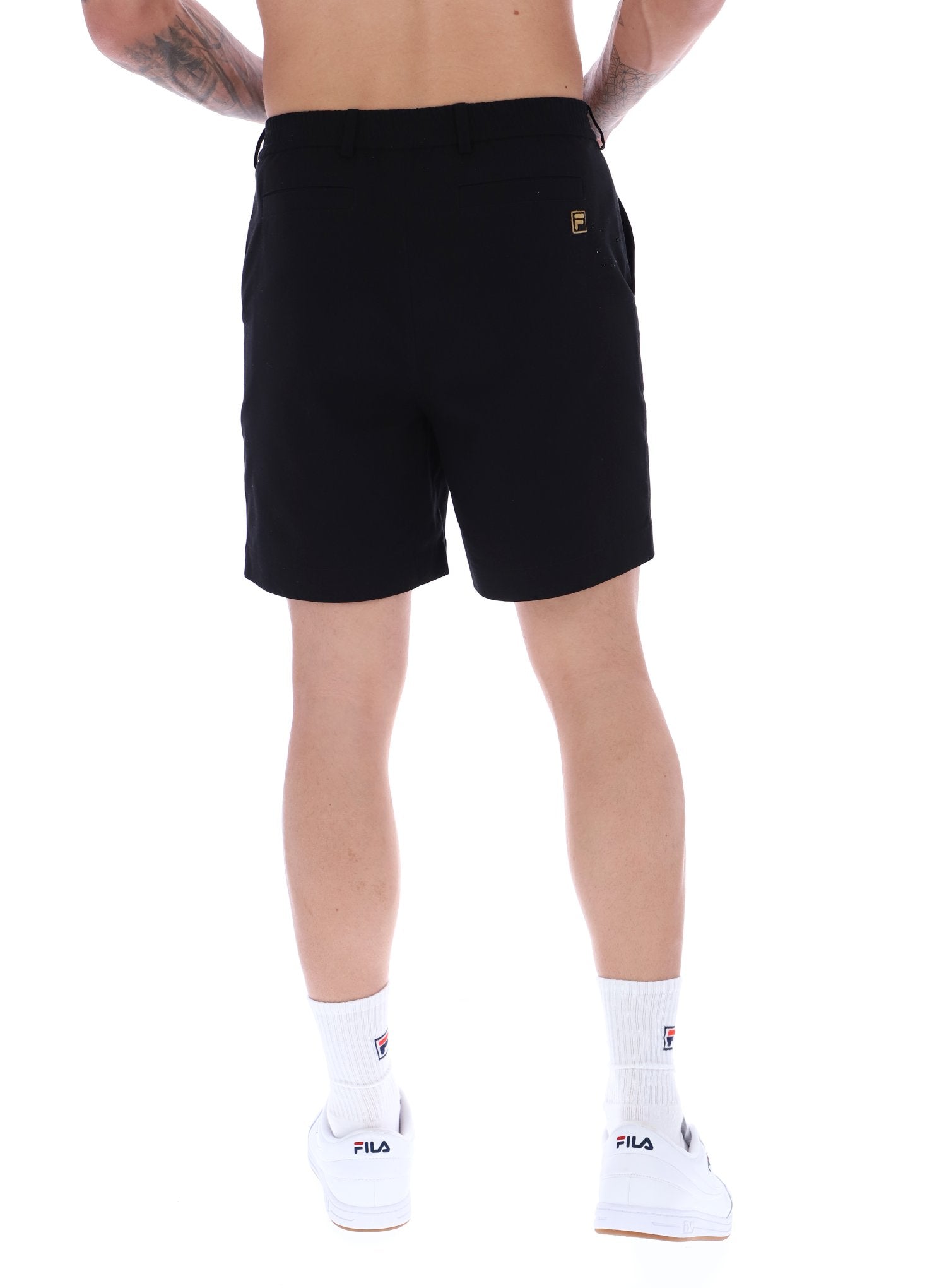 A pair of chino shorts in a black color, worn by a model standing against a plain background.