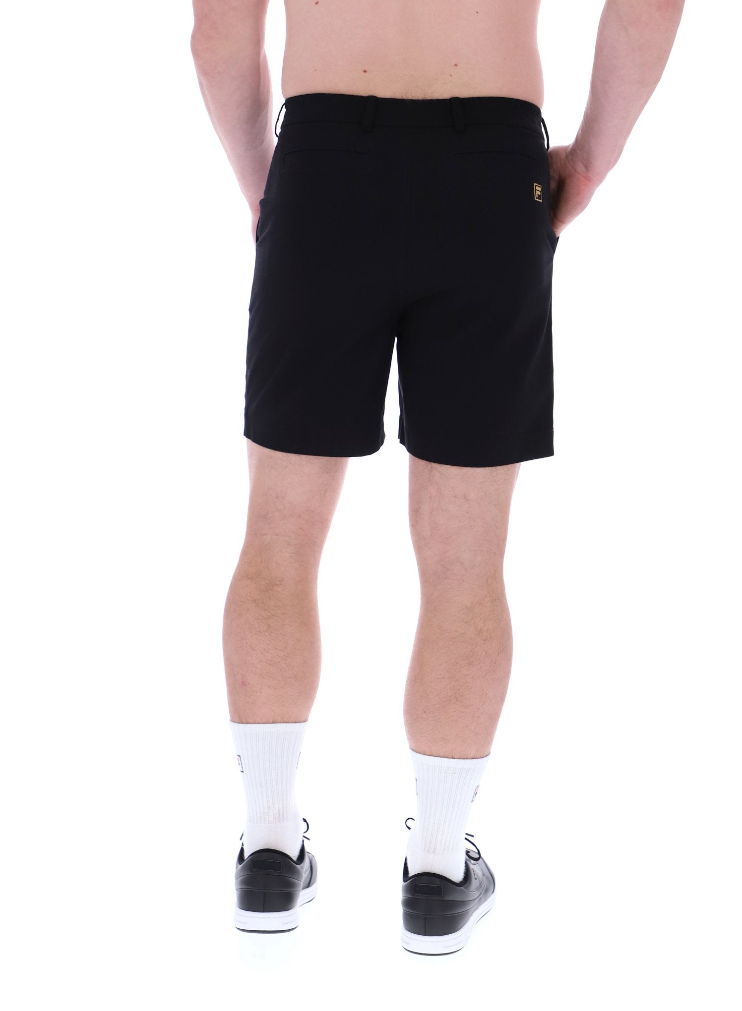 A pair of chino shorts in a black color, worn by a model standing against a plain background.