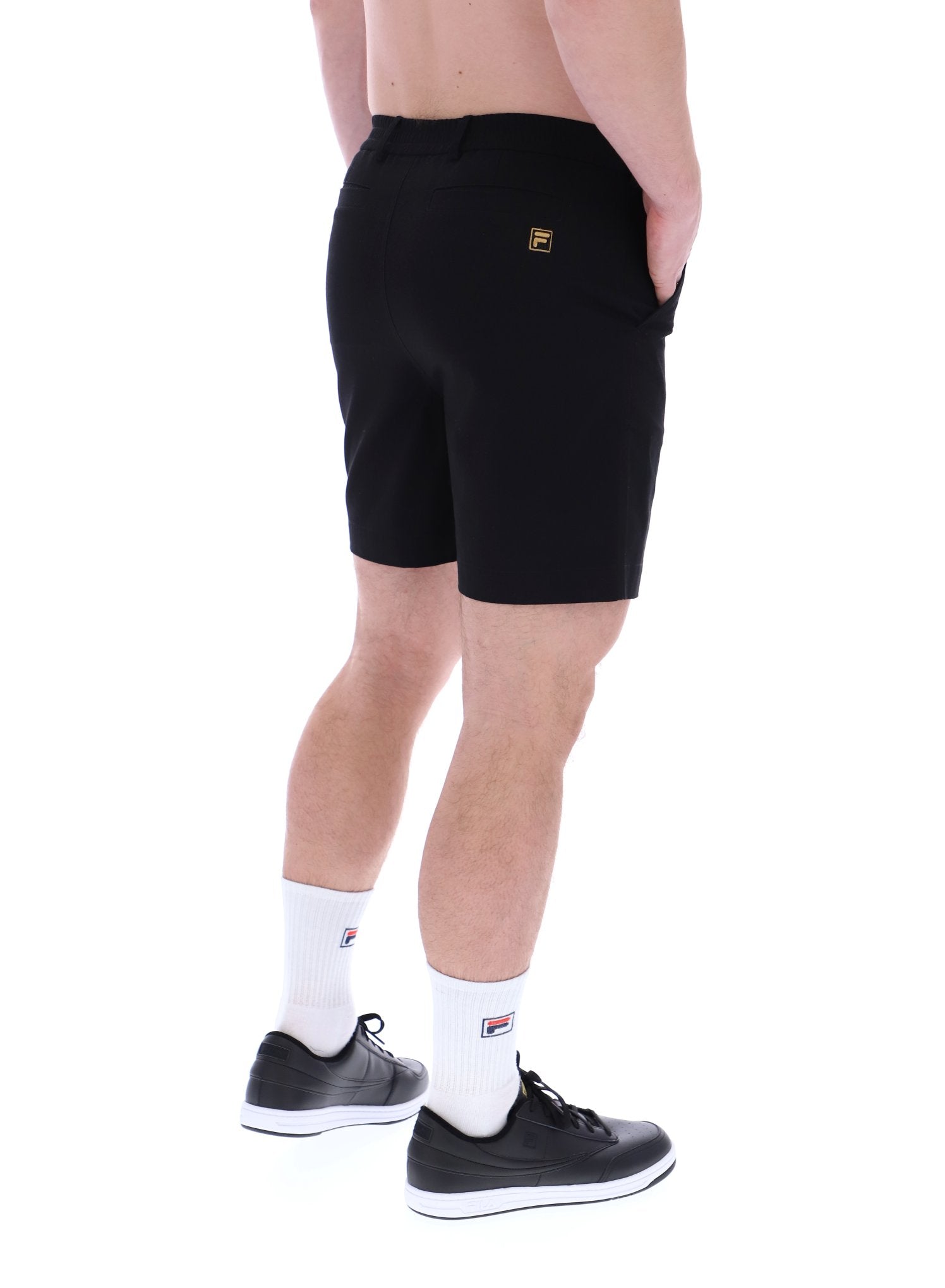A pair of chino shorts in a black color, worn by a model standing against a plain background.
