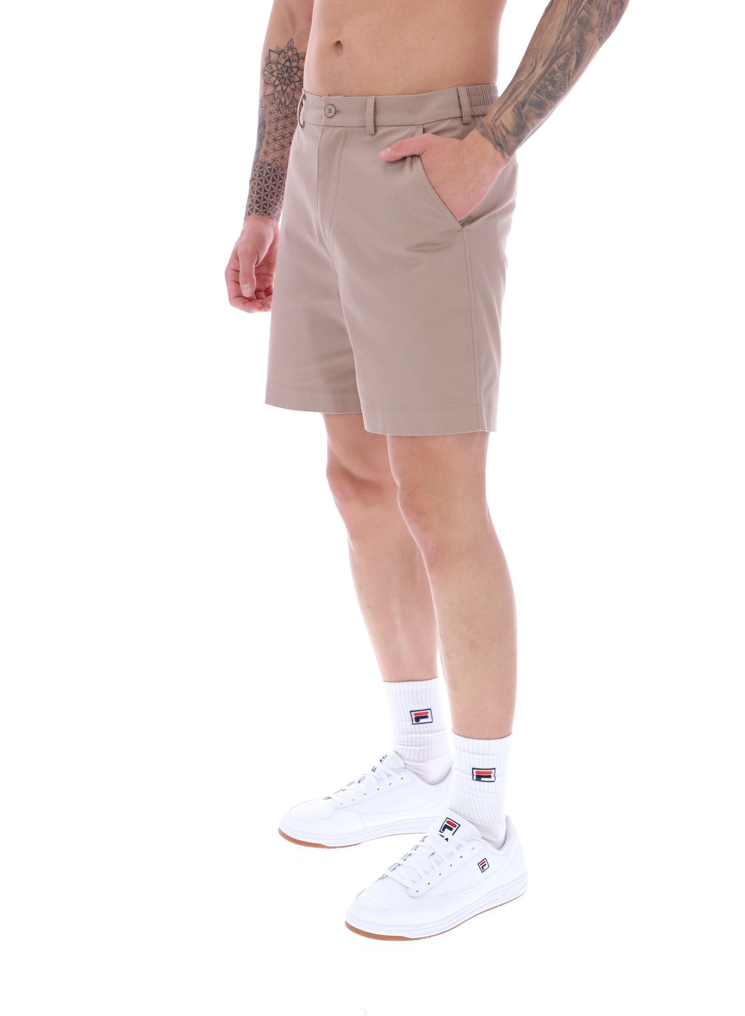 A pair of chino shorts in a neutral color, worn by a model standing against a plain background.