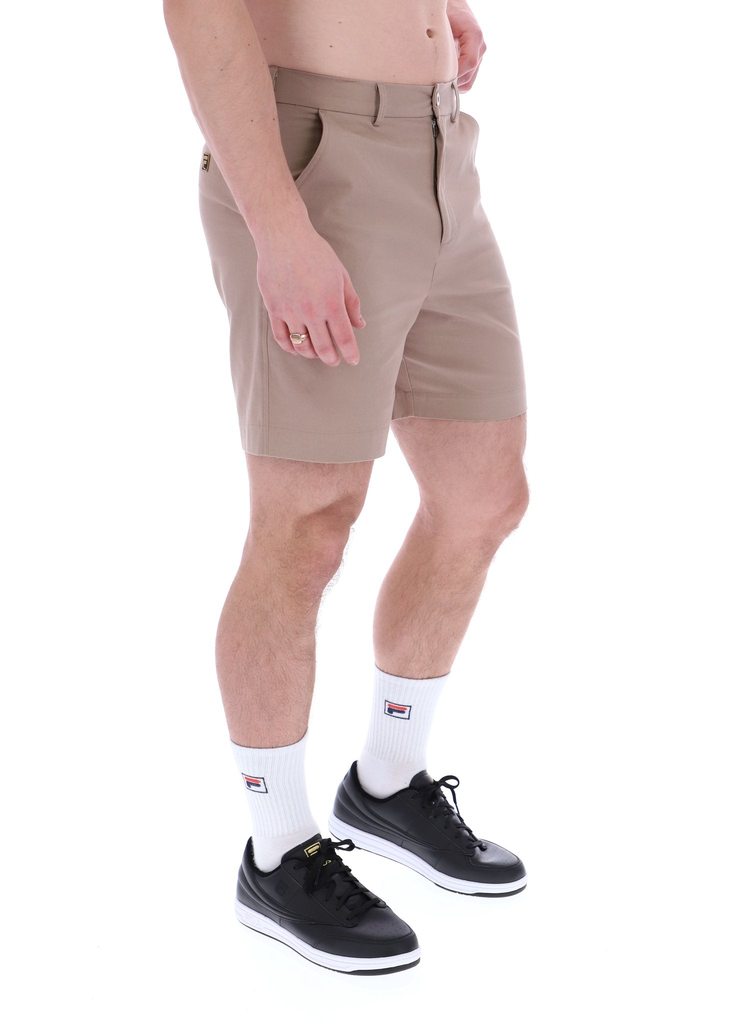A pair of chino shorts in a neutral color, worn by a model standing against a plain background.