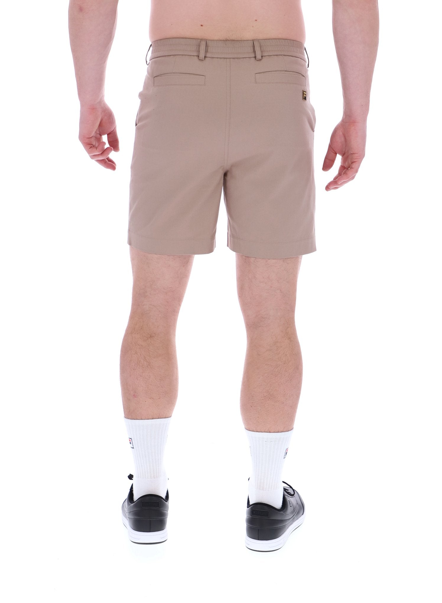 A pair of chino shorts in a neutral color, worn by a model standing against a plain background.