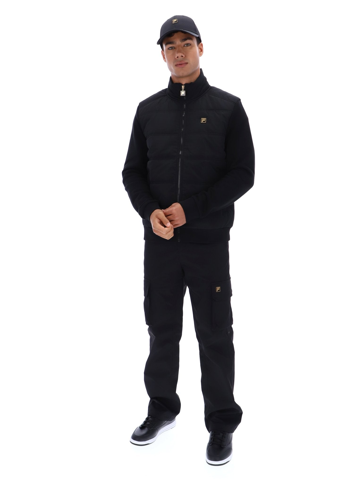 Person wearing a black outfit with a brand logo on a white background