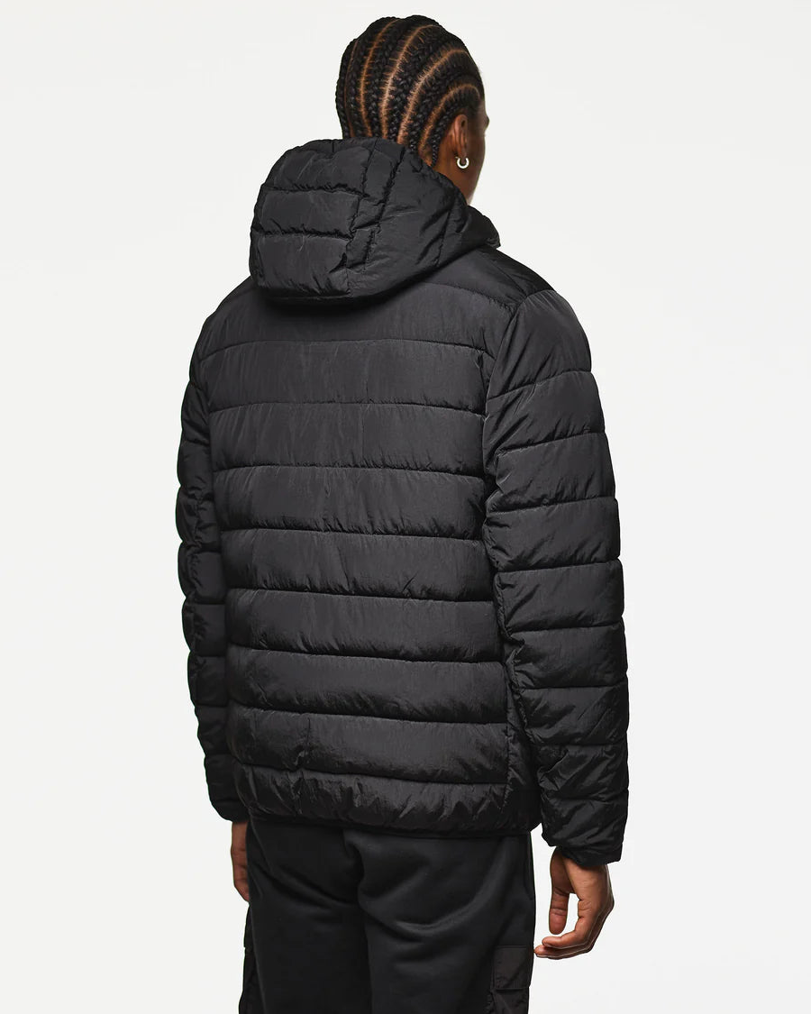Person wearing a black puffer jacket on a white background