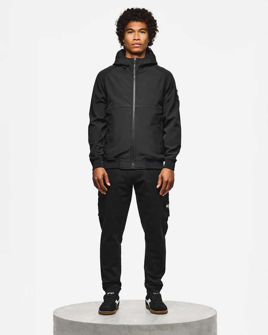 Person wearing a black jacket and pants on a white background