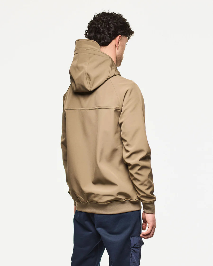 Person wearing a beige hoodie on a plain background
