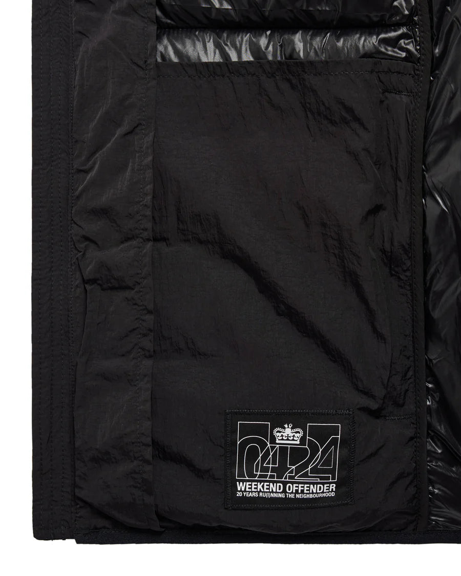Close-up of a black puffer jacket with a visible brand logo on the chest pocket.