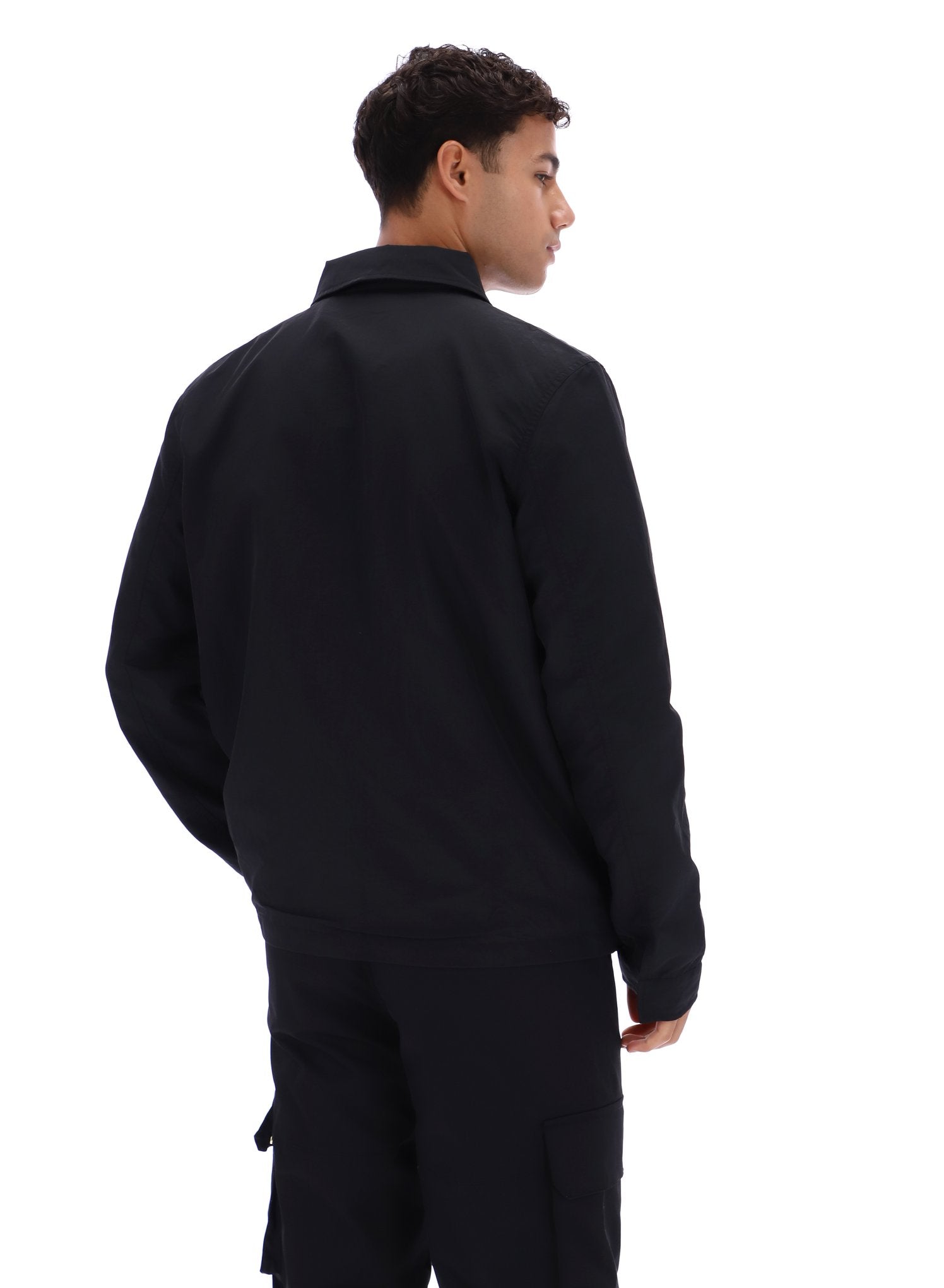 Person wearing a black outfit on a white background