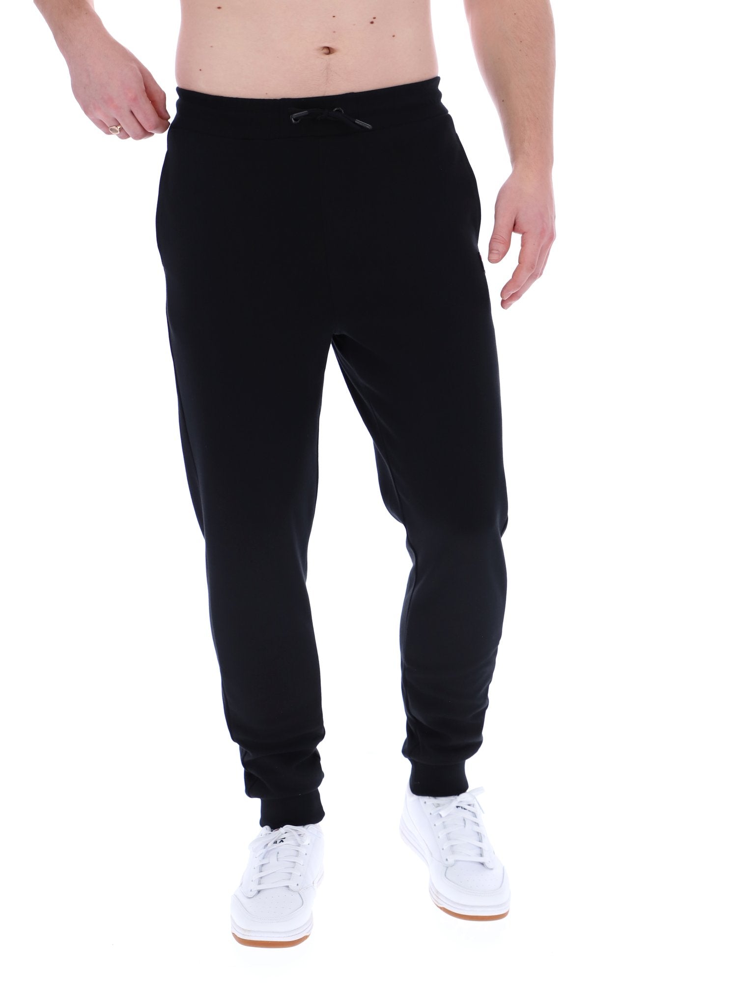 Man wearing black joggers on a white background