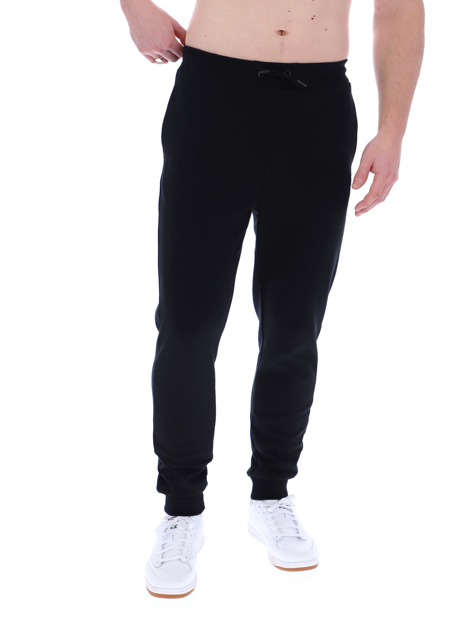 Man wearing black joggers on a white background