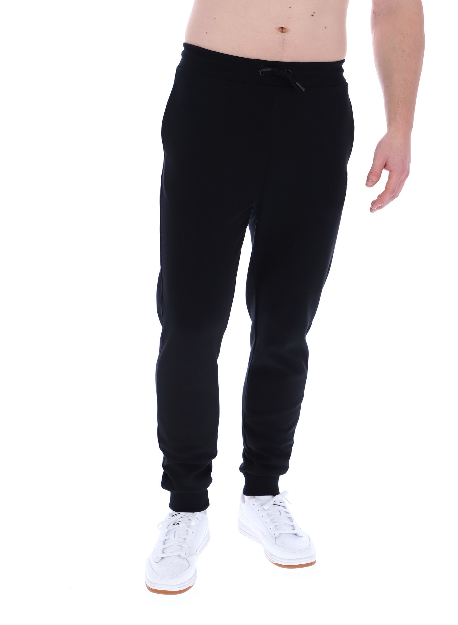 Man wearing black joggers on a white background