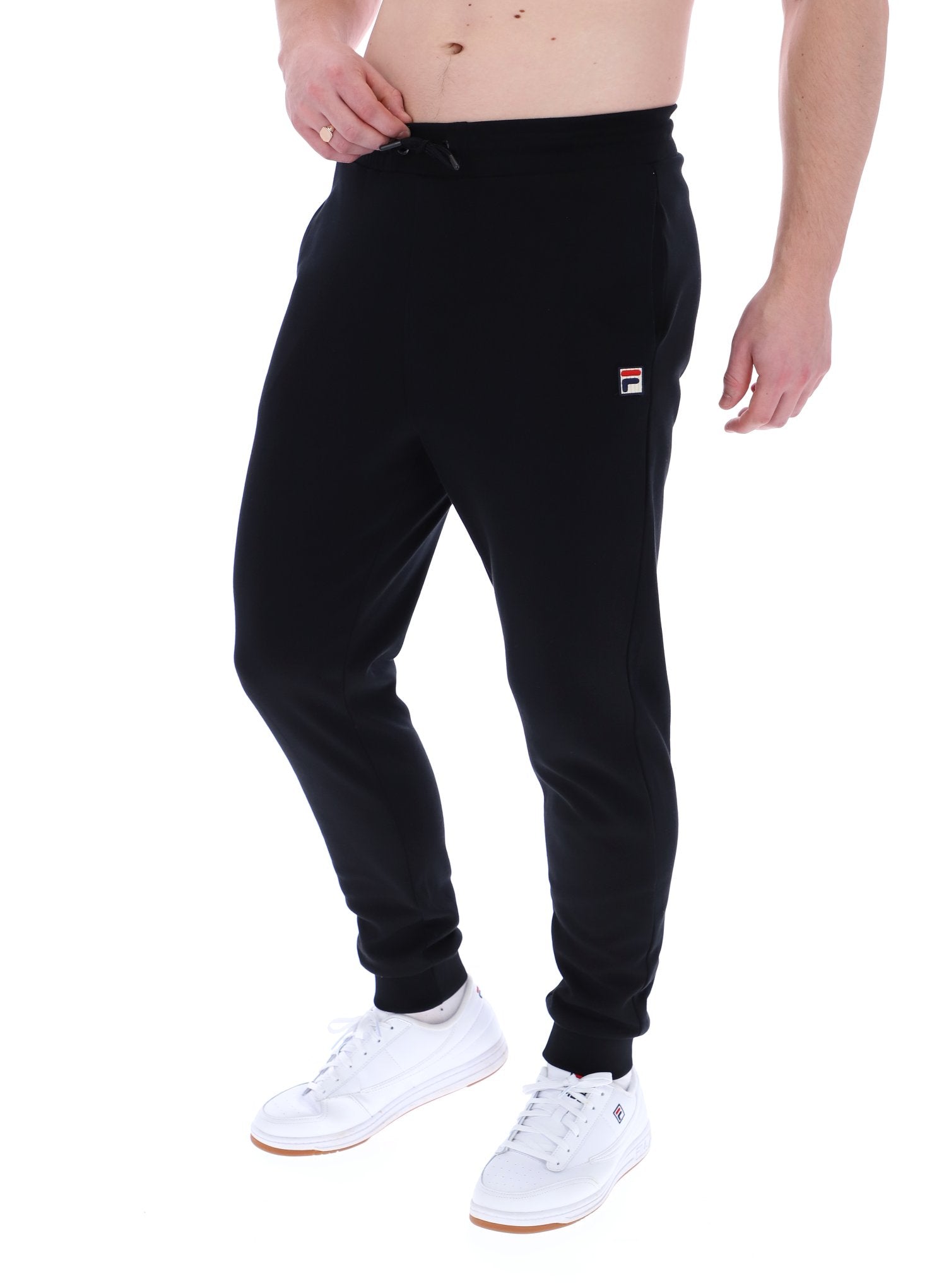 Man wearing black joggers on a white background