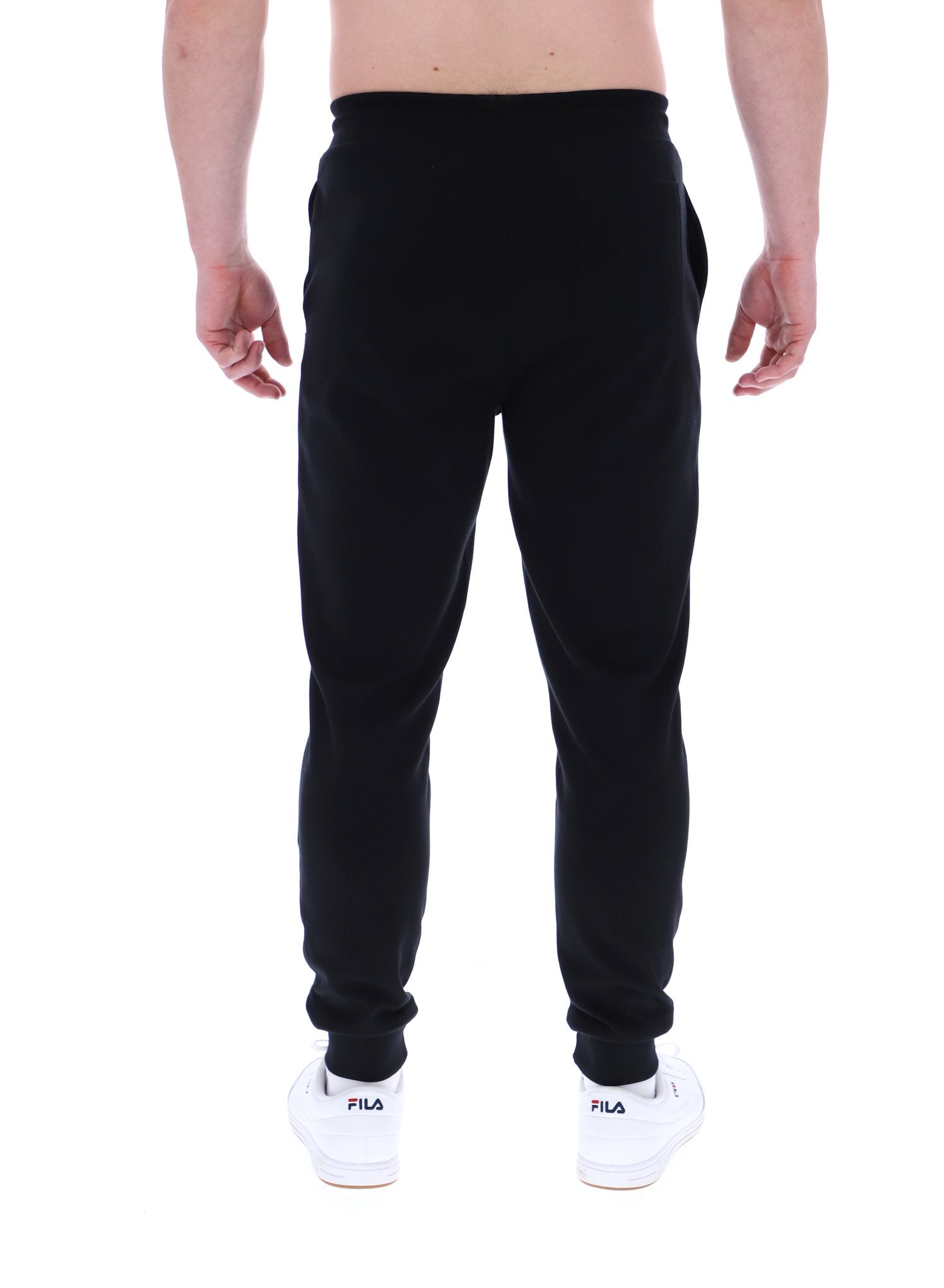 Man wearing black joggers on a white background