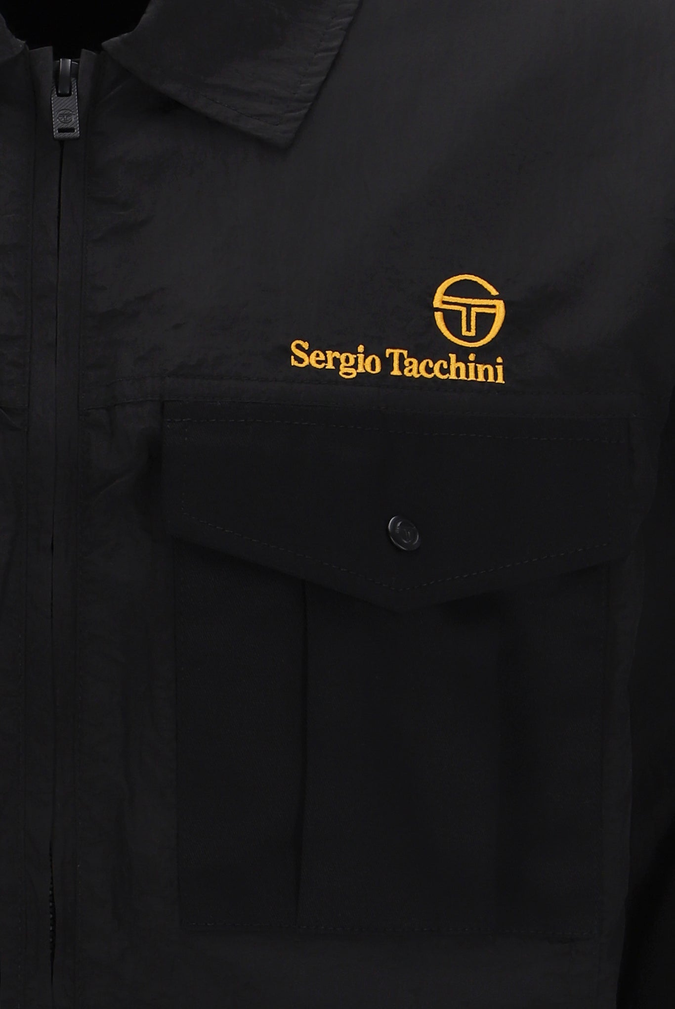 A Sergio Tacchini Luciano Shacket in black color, displaying a Spread collar, functional pockets, and embroidered branding on the chest.