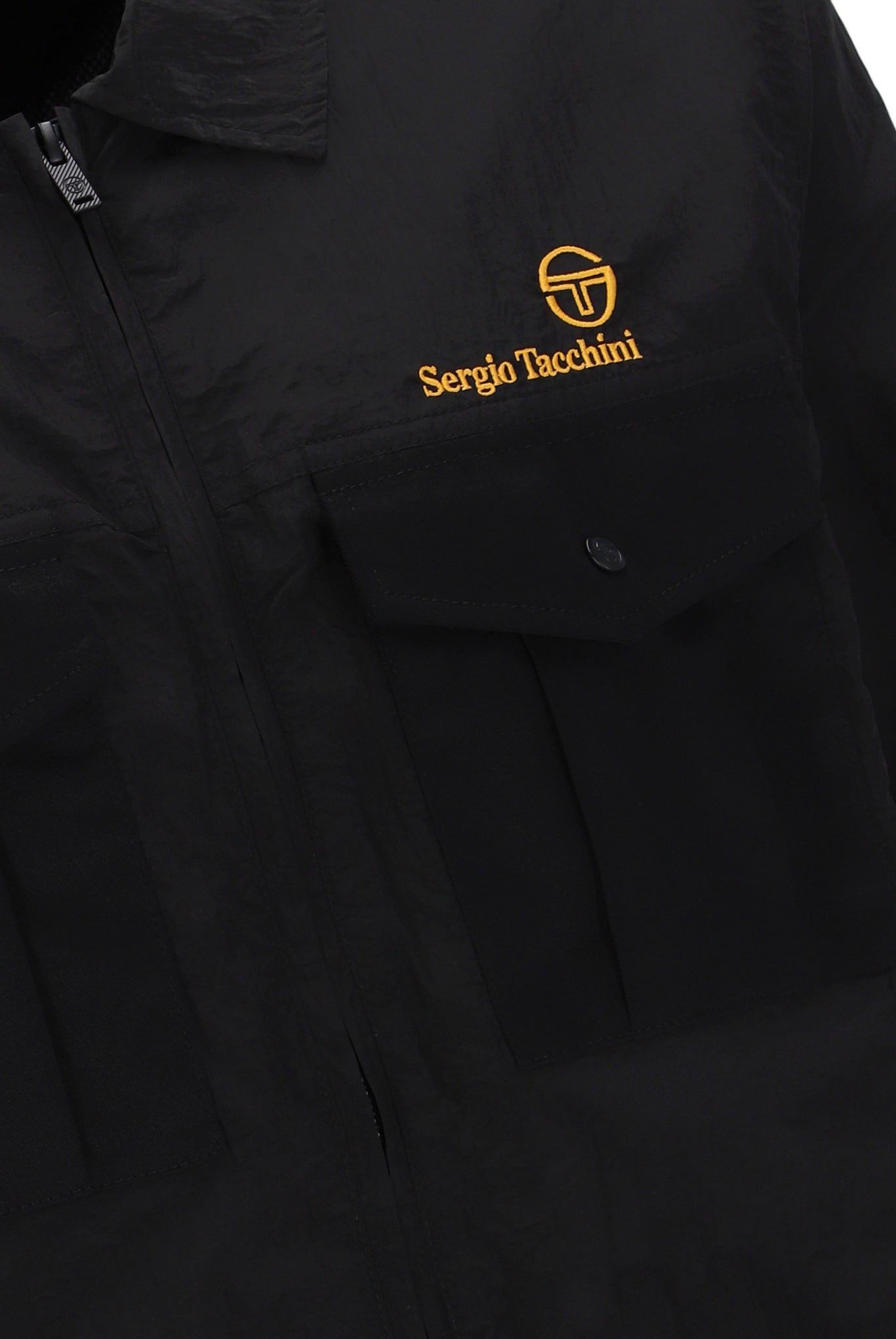 A Sergio Tacchini Luciano Shacket in black color, displaying a Spread collar, functional pockets, and embroidered branding on the chest.