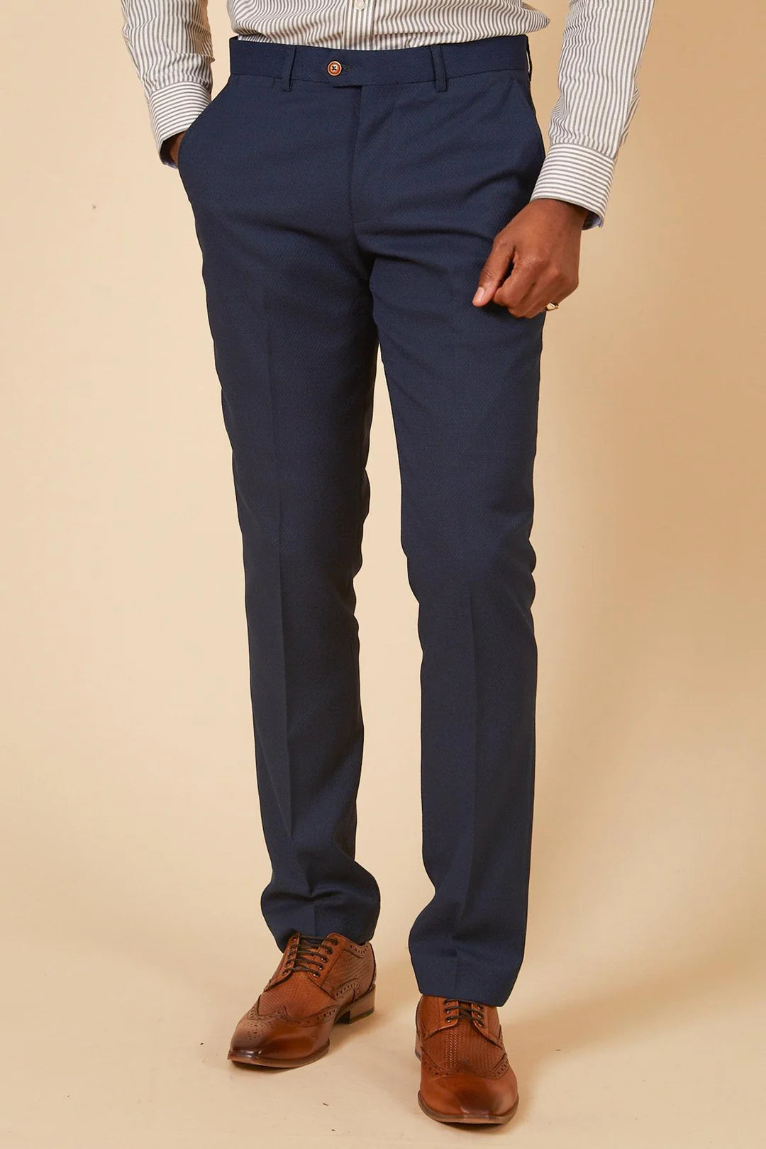 Navy blue pants worn by a person against a beige background