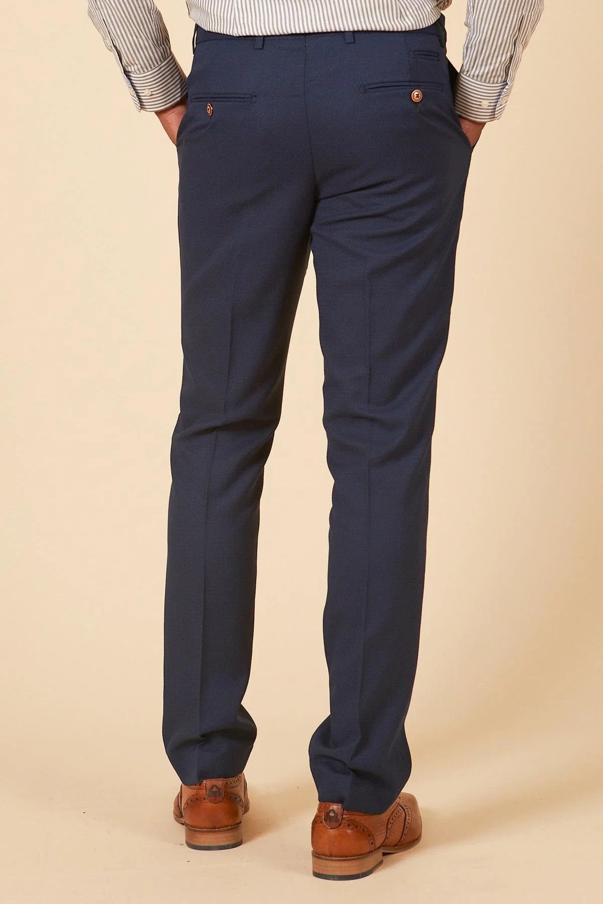 Navy blue pants worn by a person on a beige background