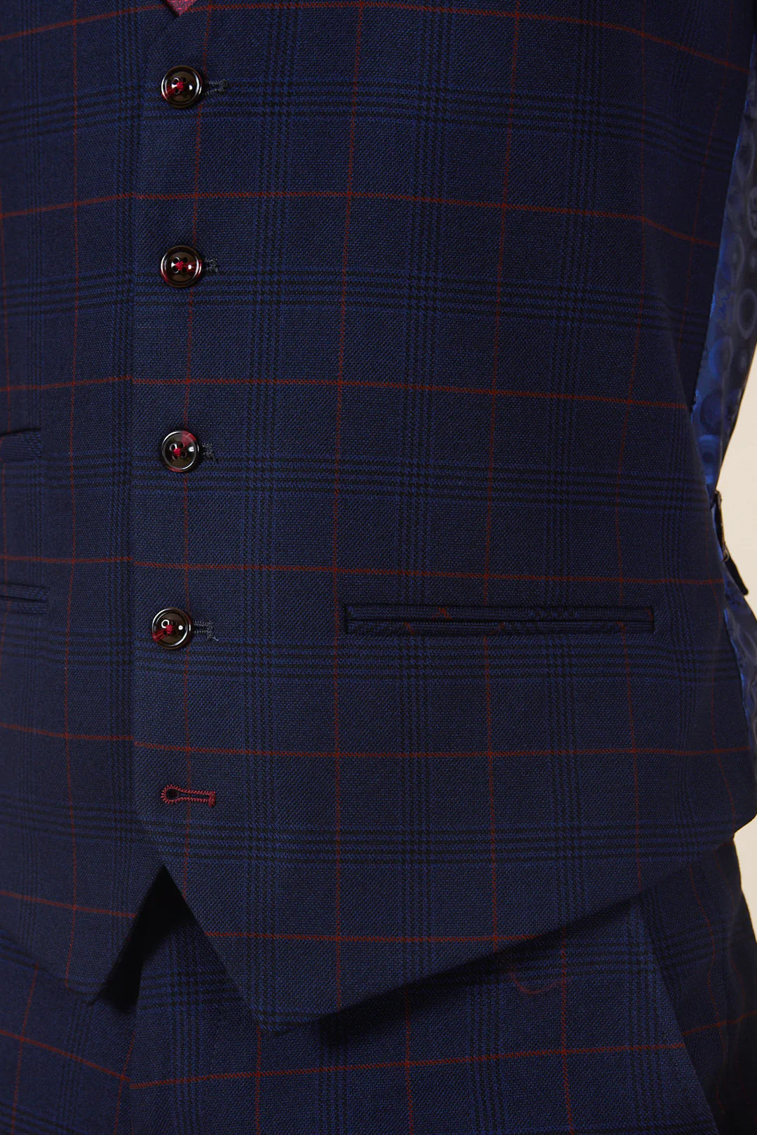 Close-up of a blue checkered vest with buttons.